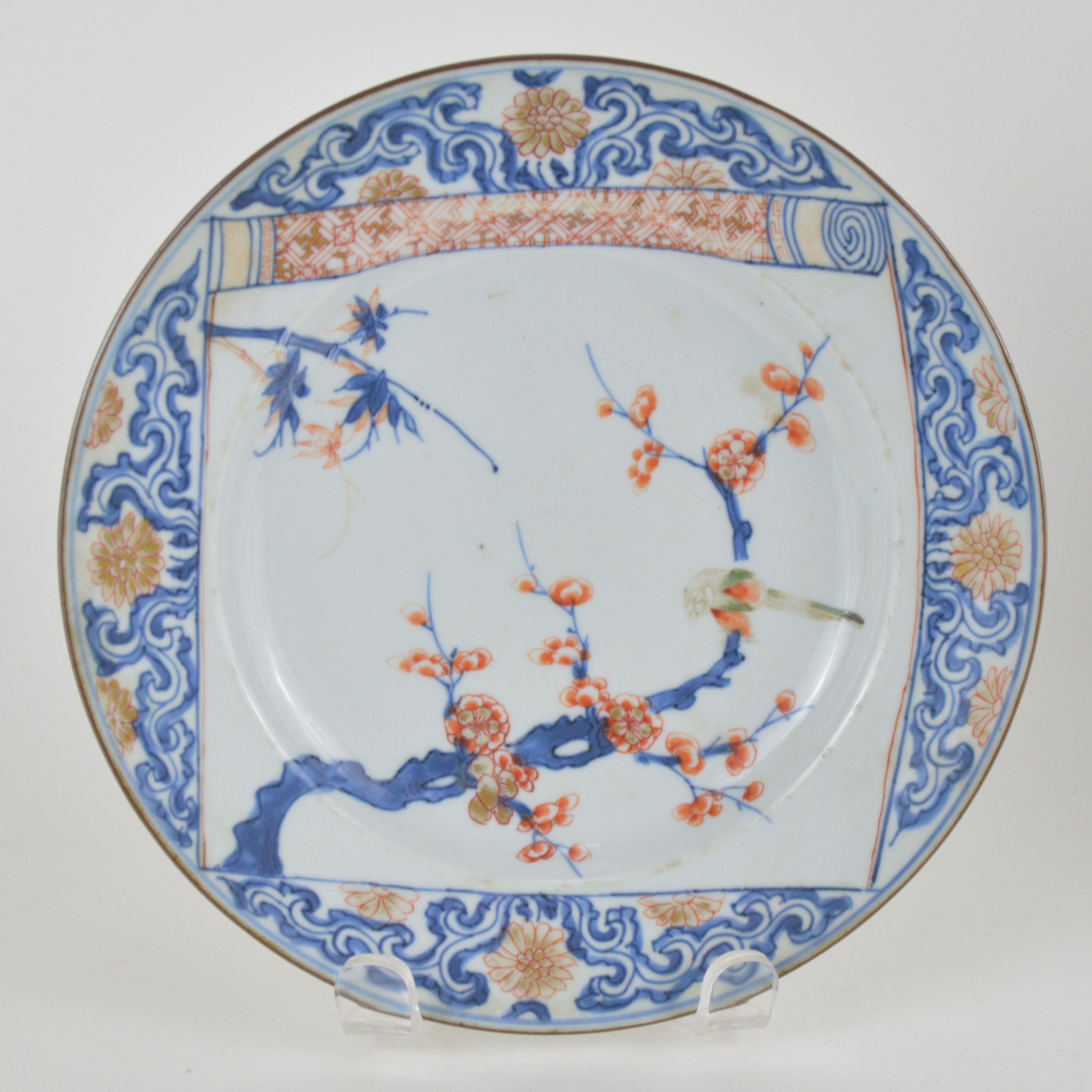 Pair of Chinese Imari plates, painted in underglaze-blue, red, and gold with various flowering branches, 18th century (Kanxi).