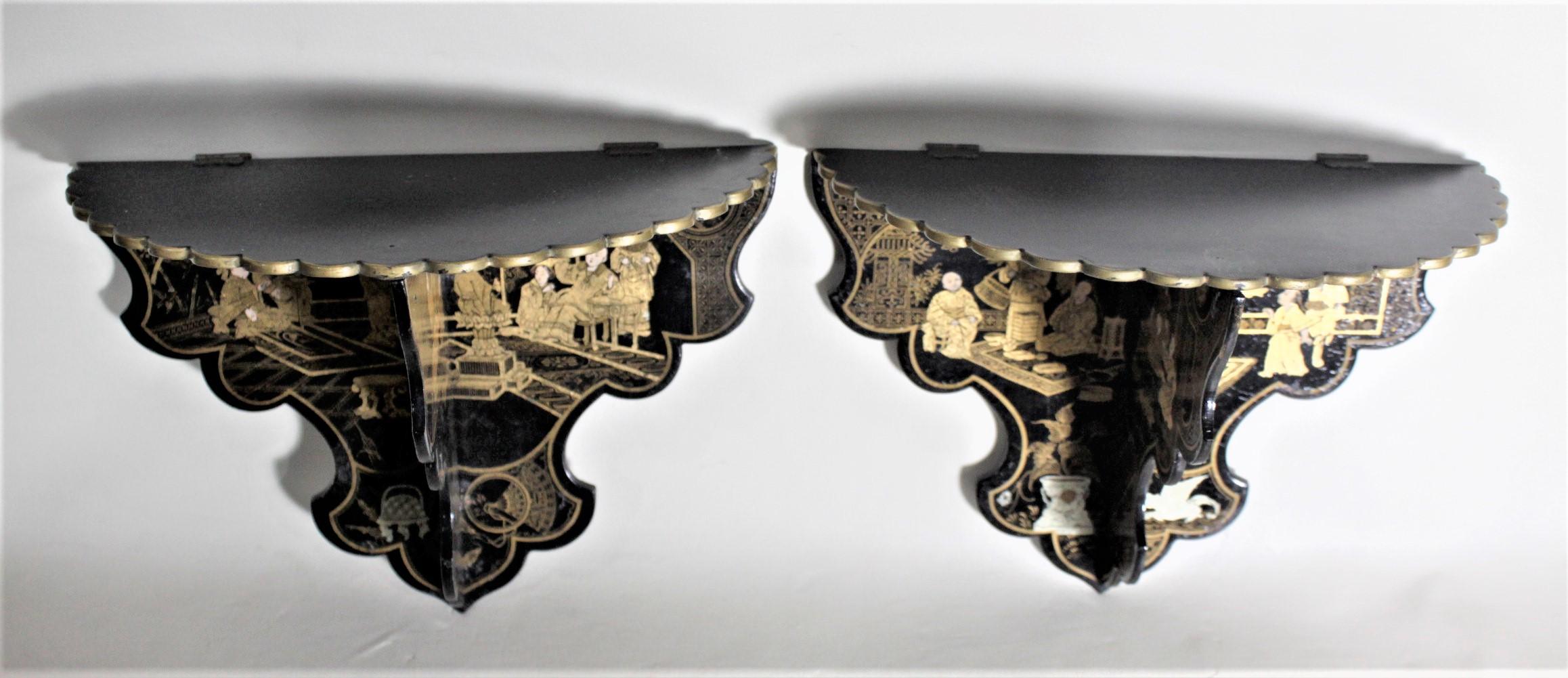 This pair of collapsible wall shelves or brackets are unsigned, but presumed to have been made in China in approximately 1920 in the period Chinese Export style. The shelves clip together with small brass clips and hinges and are done in a glossy