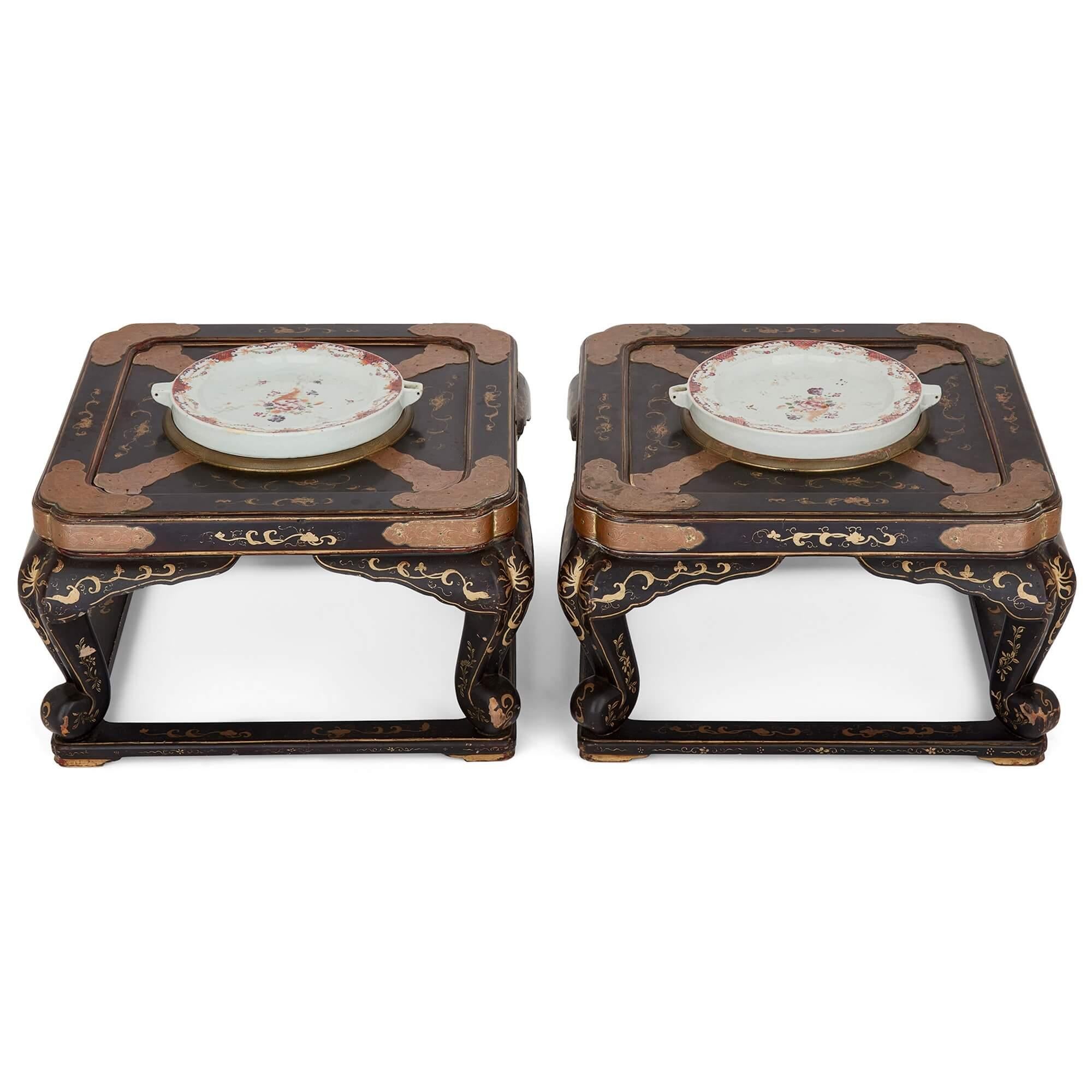 Paar antike chinesische lackierte niedrige Tische mit Warmhalteplatten aus Porzellan
Chinesisch, 18. und 19. Jahrhundert
Höhe 30cm, Breite 51cm, Tiefe 51cm

Dieses Paar lackierter niedriger Tische, die mit wärmenden Porzellantellern bestückt sind,