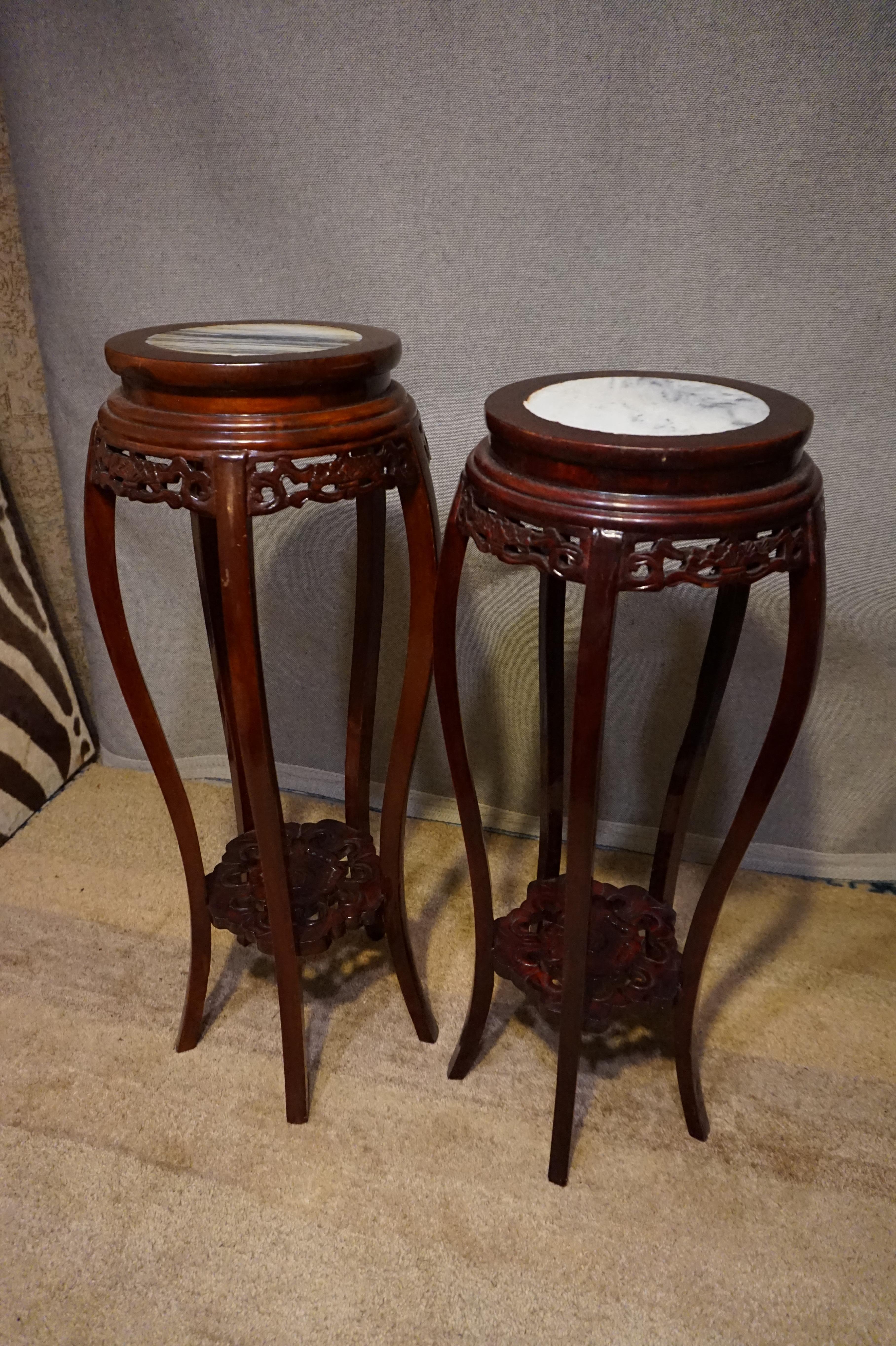 Pair of hand carved plant stands from the Republic Era. Marble tops and slight variation in height,

circa 1920s.