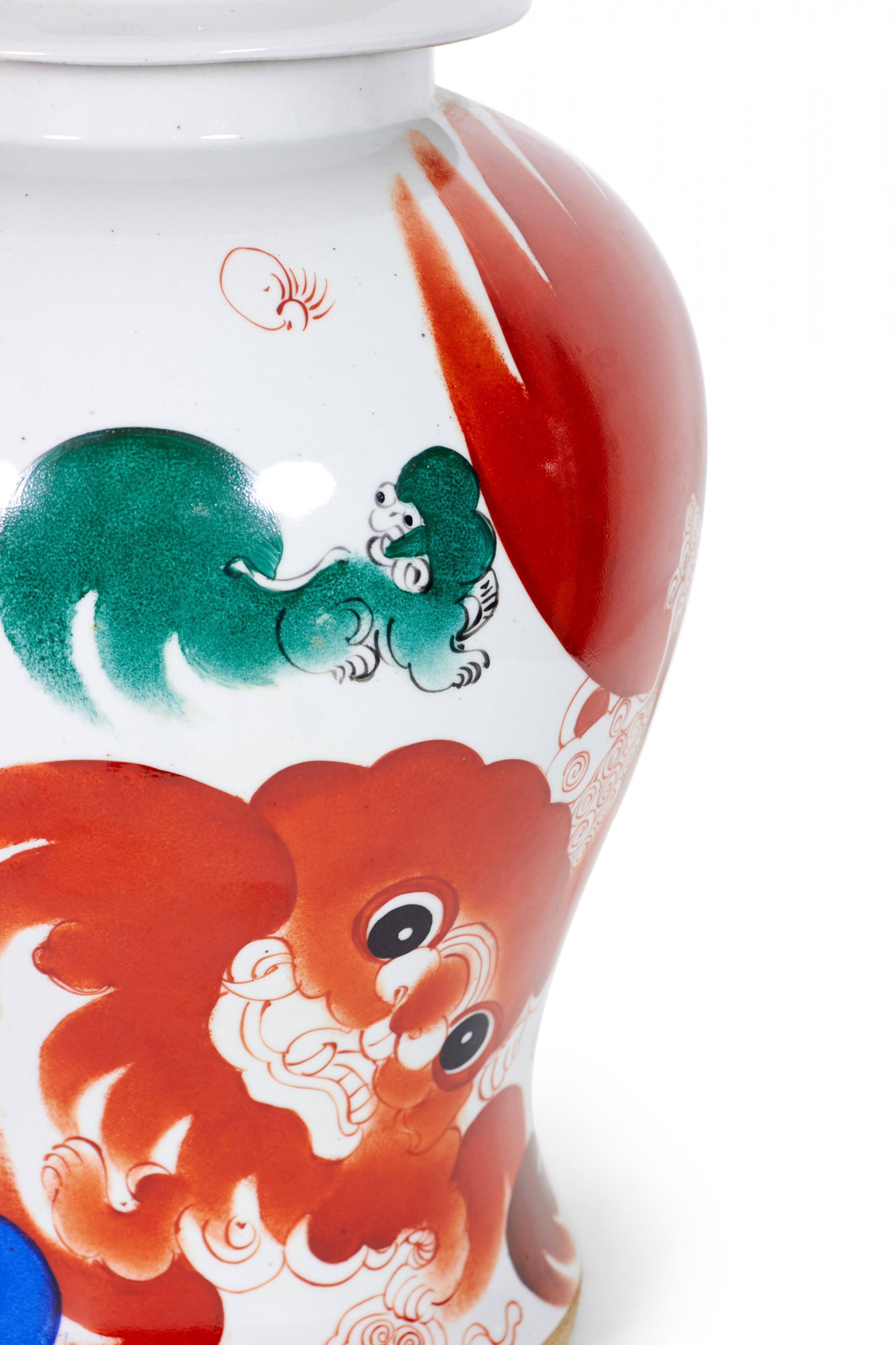 PAIR of Antique Chinese (late 19th-early 20th Century) porcelain lidded ginger jars with a pattern featuring swirling orange foo dogs with green accents against a gray-beige background. (PRICED AS PAIR)

Condition: Good; Wear consistent with age and