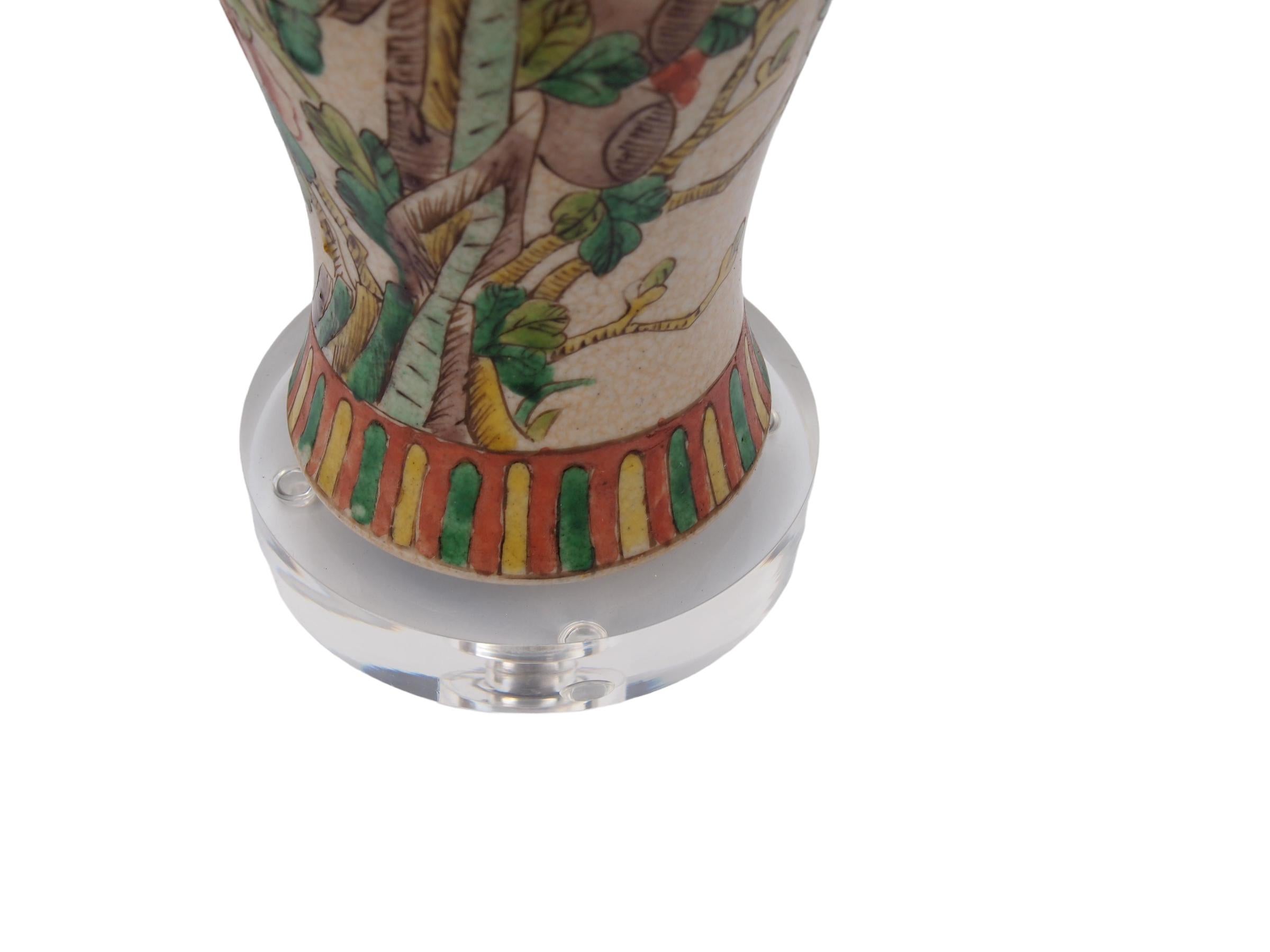 Pair of early 20th Century Chinese porcelain vases custom mounted on lucite bases. Each vase decorated with a perched birds  of paradise and colorful vegetation on a brown ground.
Wired and in working condition.
Height to bottom of harp 17