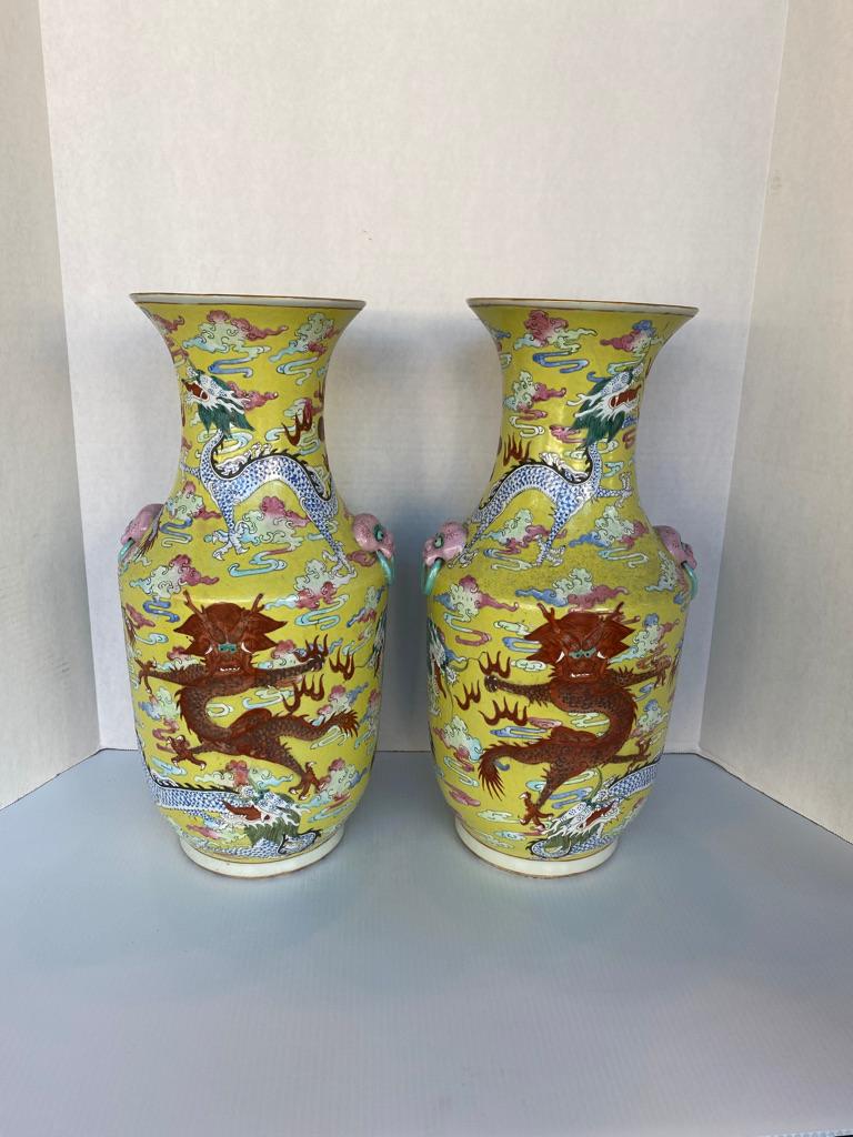 What a wonderful pair of Qing Dynasty vases yellow ground with pink and blue having a red dragon to the center of both chasing 