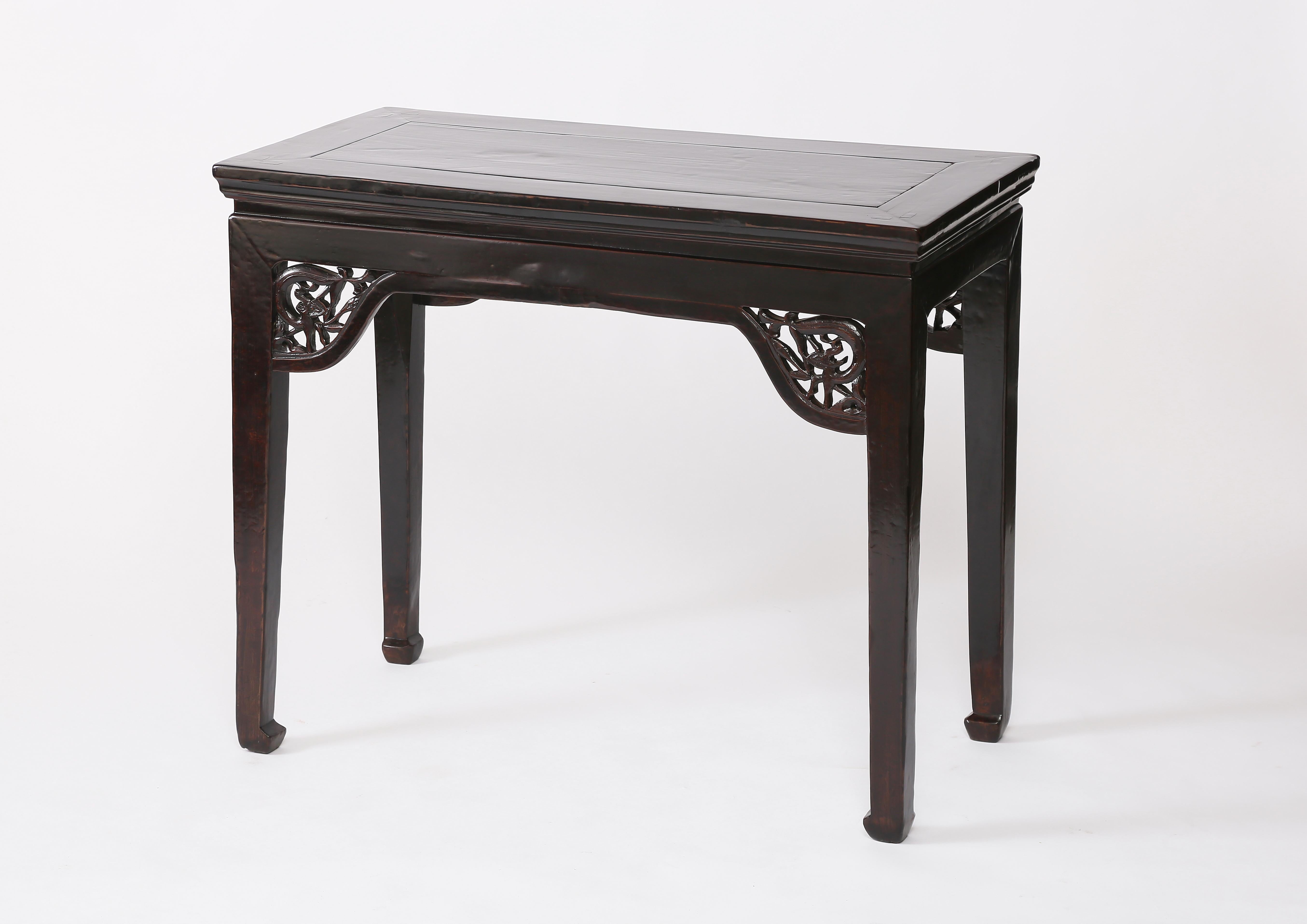 Each of the pair with an ice-plate edged frame enclosing a floating top panel, above a waist, supported on square-sectioned corner legs, decorated with open-carved stylized dragon spandrels, terminating in horse hoof feet 

Lacquer over Elmwood