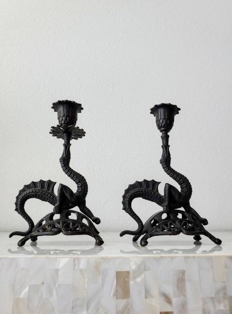 A charming pair of whimsical late Victorian era Gothic Revival Chinoiserie cast iron figural dragon shaped candlesticks. Stylized sculptural form, elegantly flowing curvilinear lines, ornate richly detailed, the antique oriental pair having a