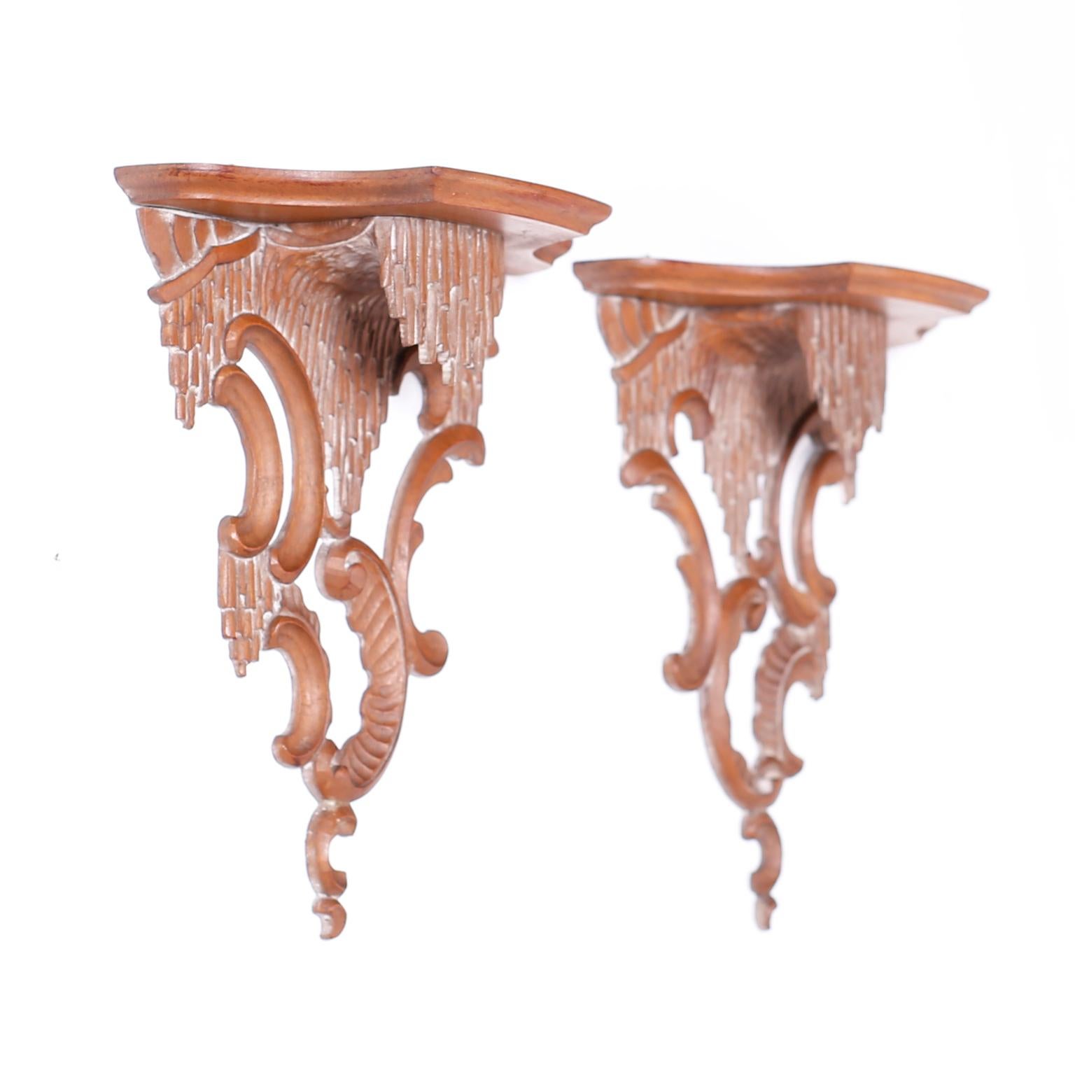 Refined pair of Chippendale style wall brackets expertly carved from mahogany with classical form.