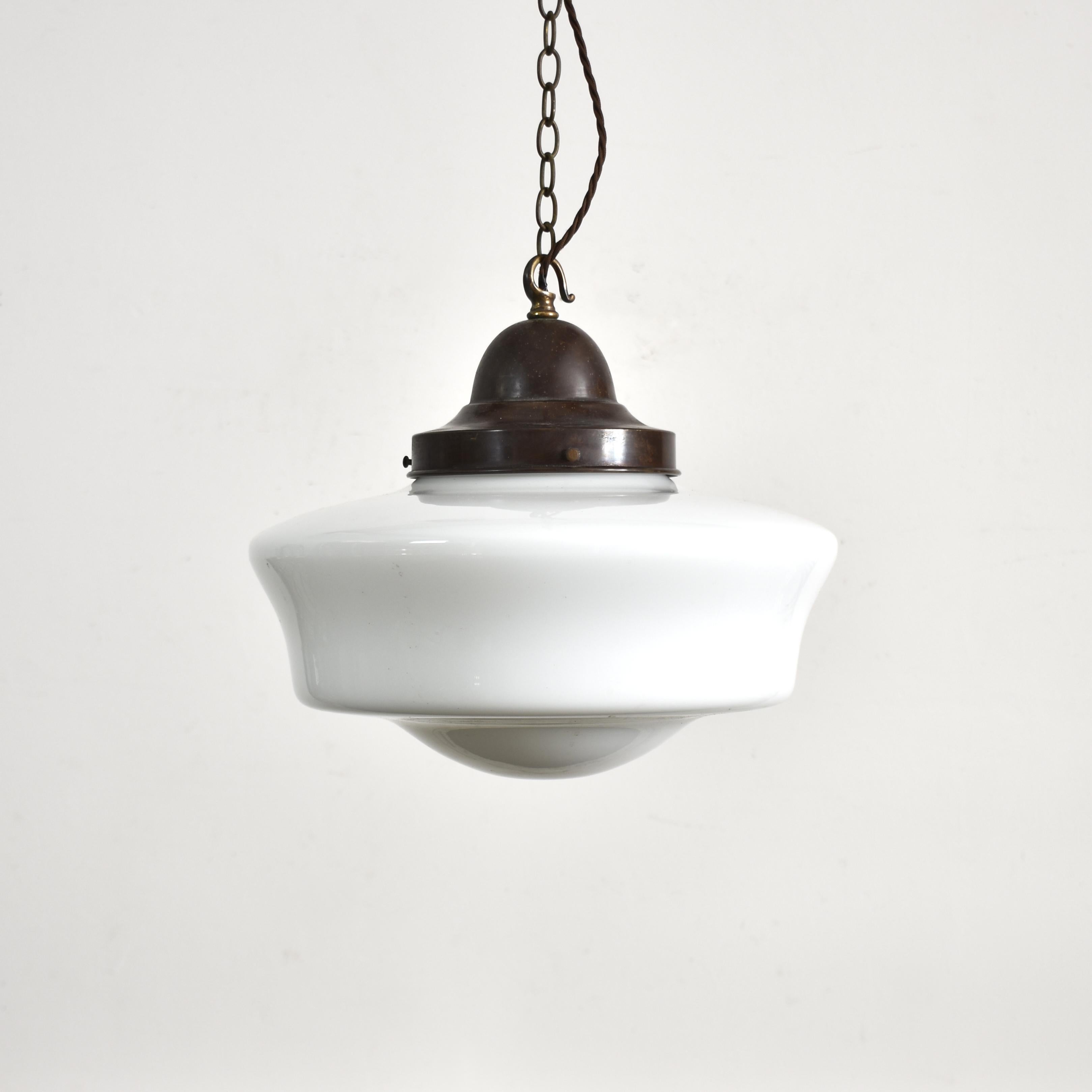 Pair of Antique Church Opaline Pendant Lights

A pair of original opaline glass pendant lights. The lights have milk glass opaline shades and original aged brass hanging galleries. The gallery finish has been left untouched in it original