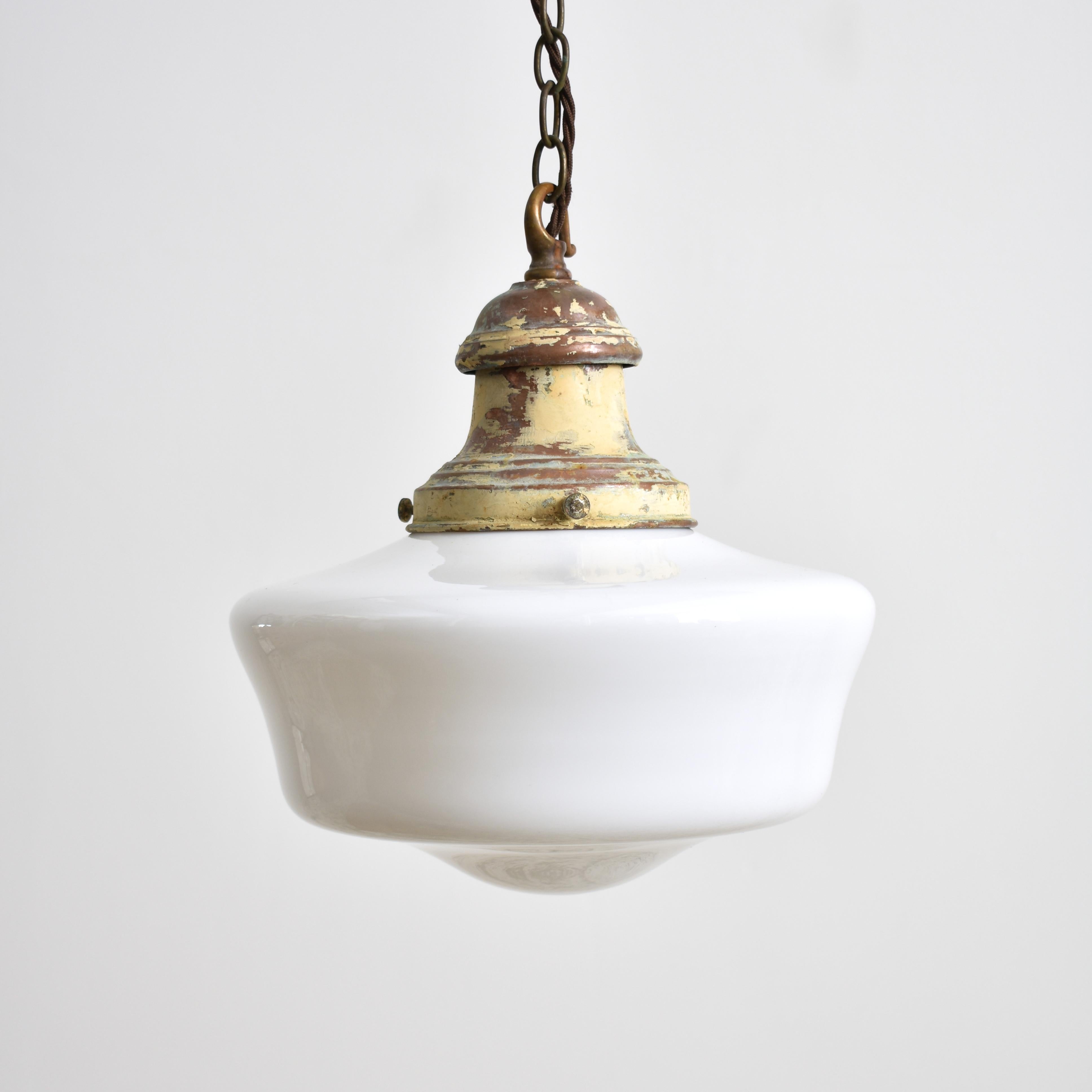 Pair of Antique Opaline Pendant Lights

A pair of original opaline glass pendant lights. The lights have milk glass opaline shades and original aged copper hanging galleries. The gallery finish has been left untouched in it original