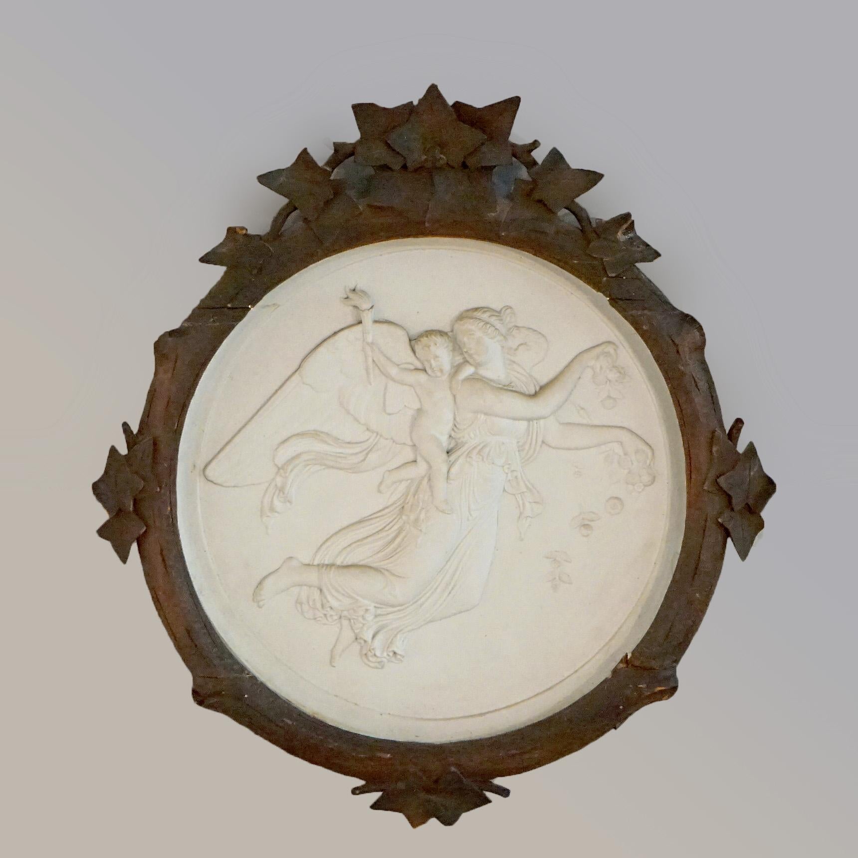 A pair of antique Classical wall plaques offer parian porcelain with mother angels with their babies in relief, seated in carved walnut frames, 19th century

Measures- 20''H x 18.25''W x 1.75''D