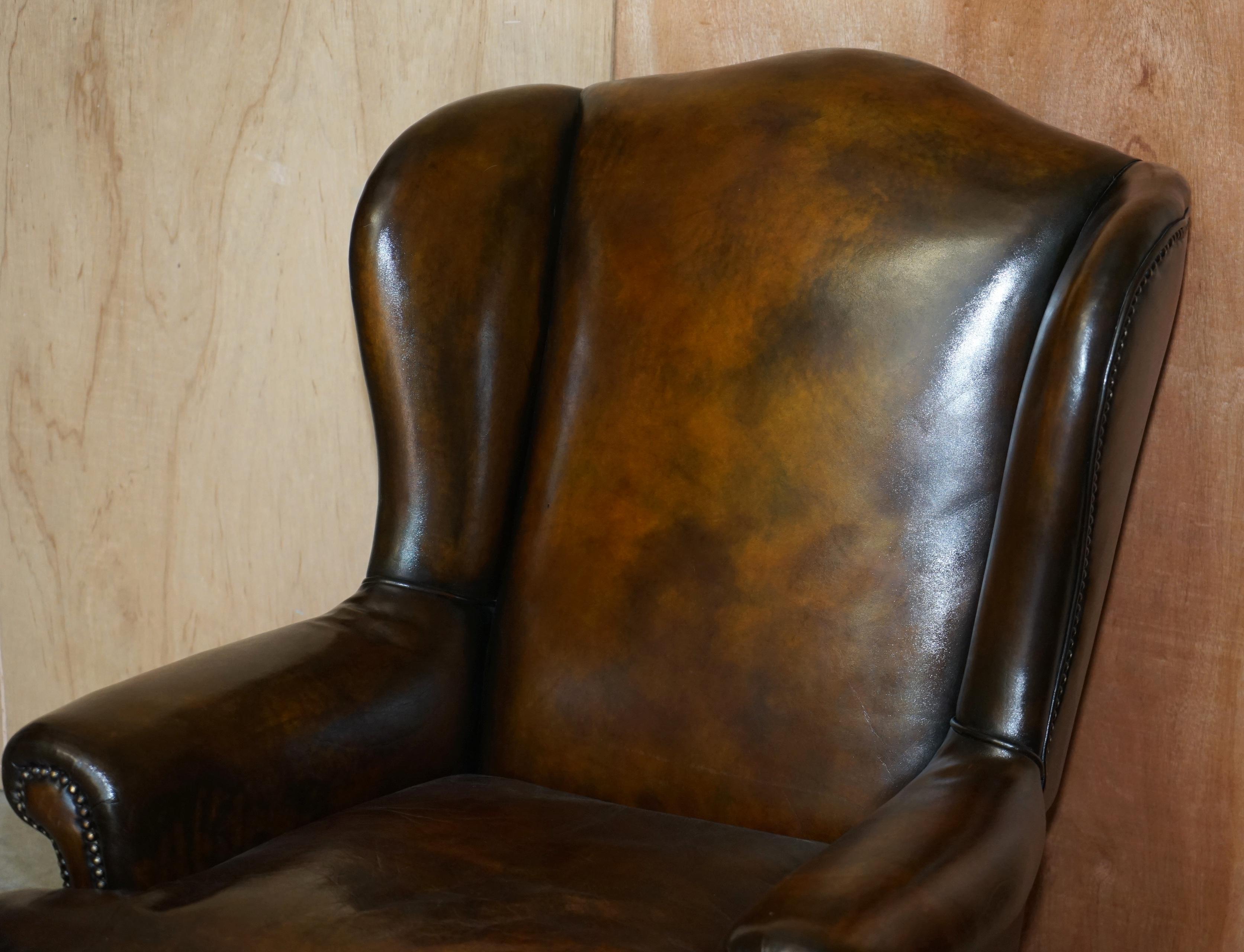 English Pair of Antique Claw & Ball Restored Hand Dyed Brown Leather Wingback Armchairs