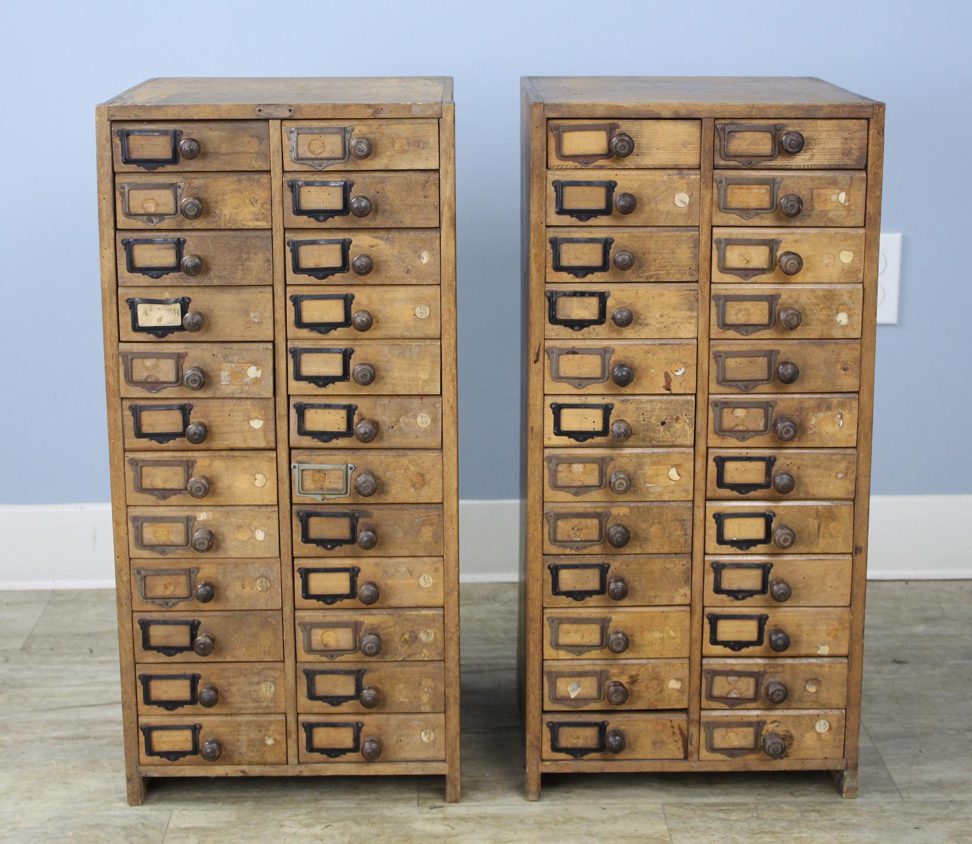 An interesting pair of French collector’s drawers with original category labels. The knobs are wonderfully patinated from years of use. The variety of colored metal catalog card holders, along with the evenly distributed distress, has real visual