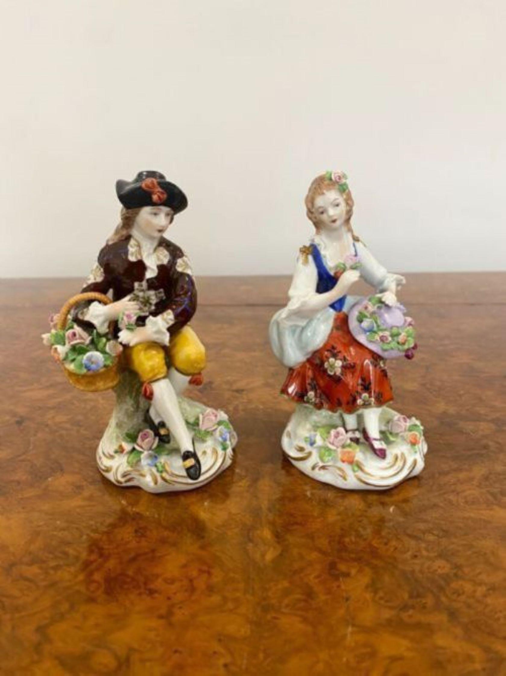 Pair of antique continental porcelain figures holding a basket of flowers and a hat in wonderful green, red, blue, yellow and white colours