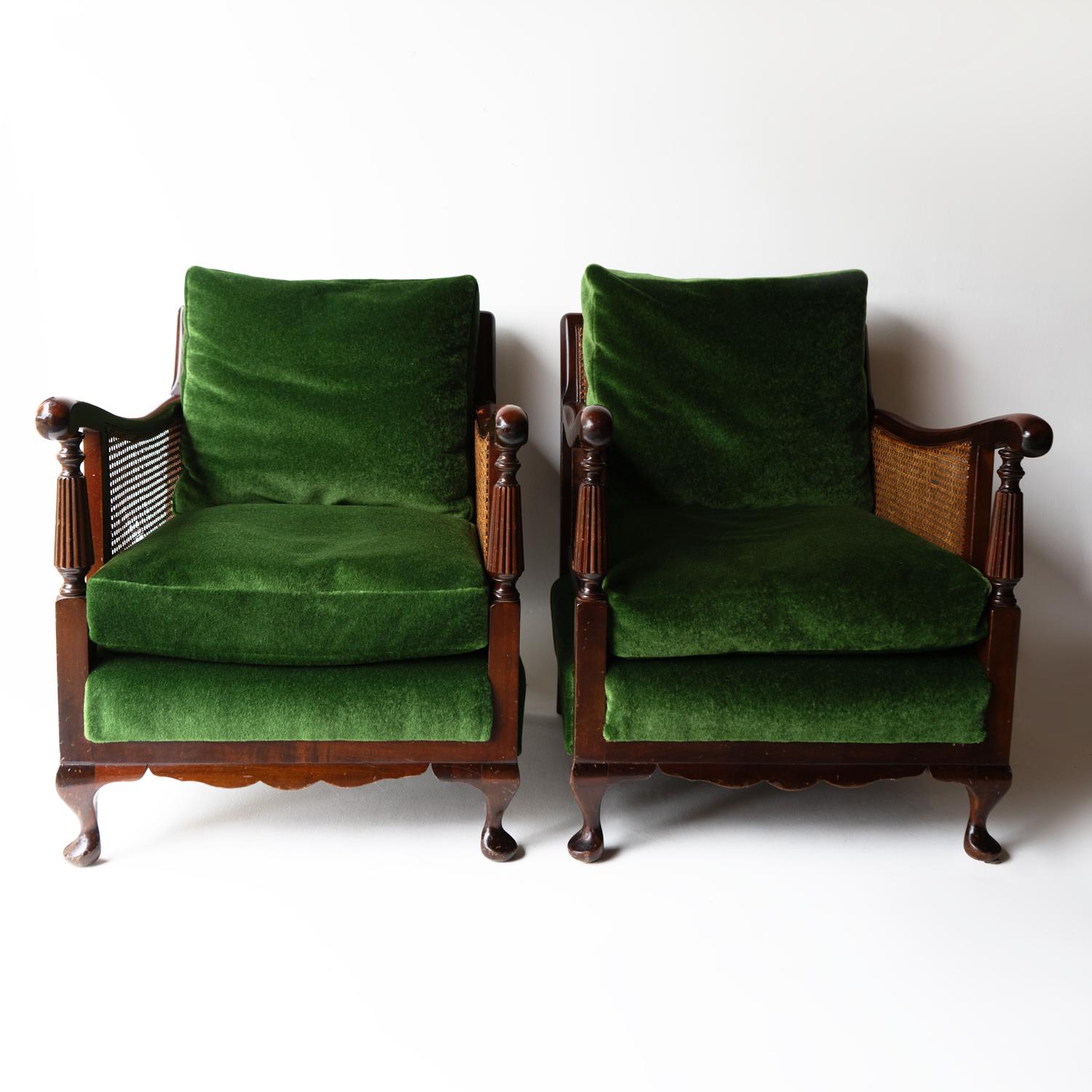 CANE UPHOLSTERED LOUNGE CHAIRS

A handsome and generous pair of comfortable lounge chairs.

Mahogany frames with decorative turned front supports and raised on squat cabriole legs. There is an element of Eastern influence in the design of the shaped