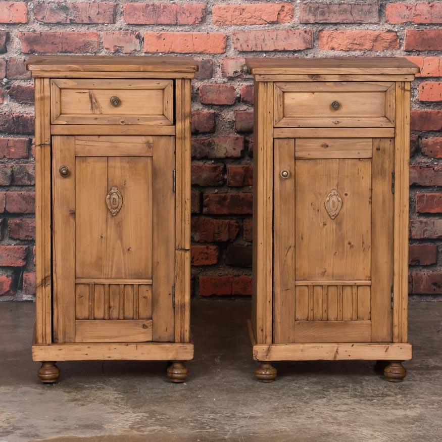 This pair of quaint European nightstands has simple lines enhanced by a waxed finish, bringing out the warmth of the natural pine. The drawer over door configuration makes them easy to place as side tables or nightstands, and add easy function to a
