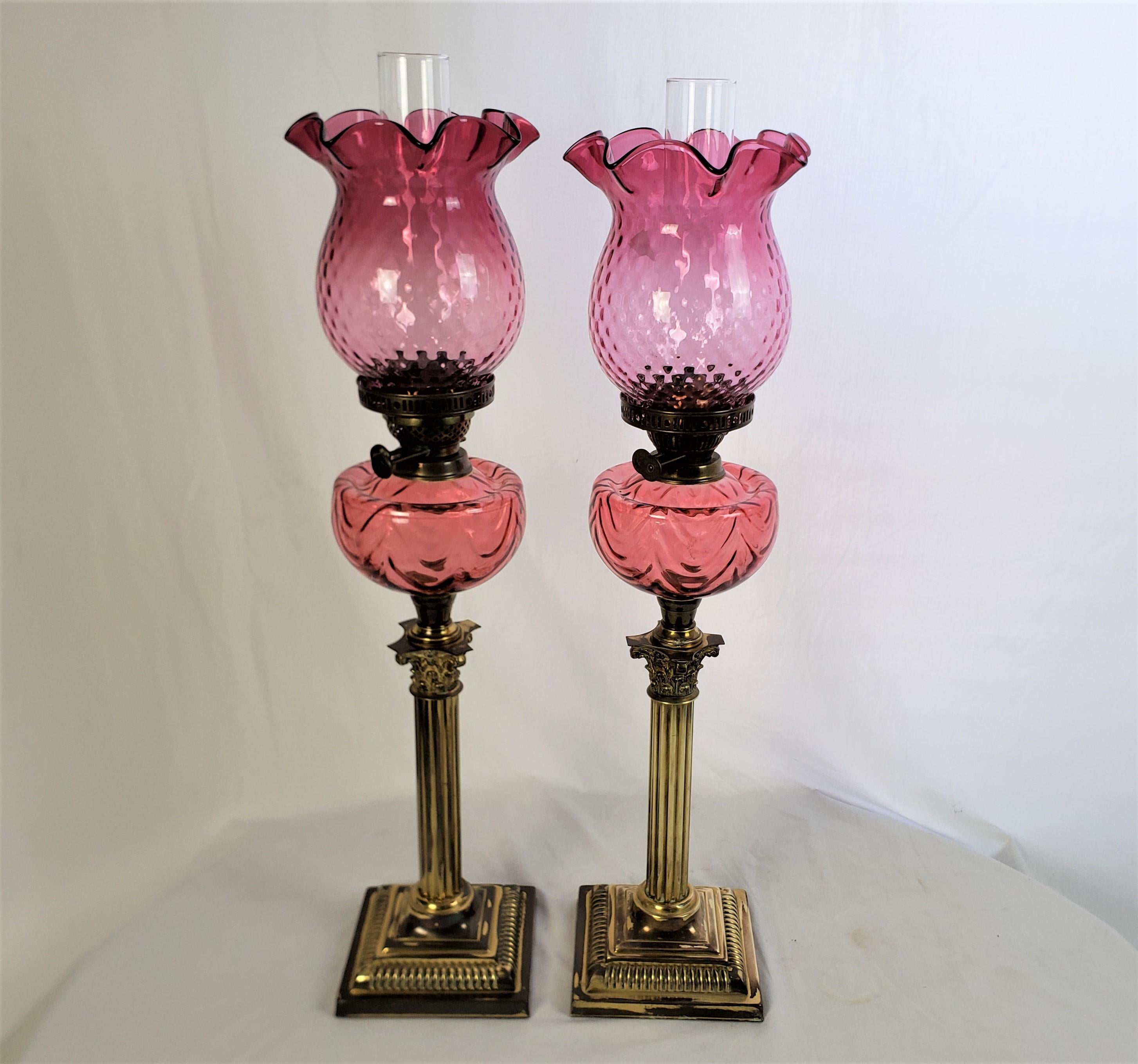 High Victorian Pair of Antique Cranberry & Brass Corinthian Column Banquet or Parlor Oil Lamps For Sale