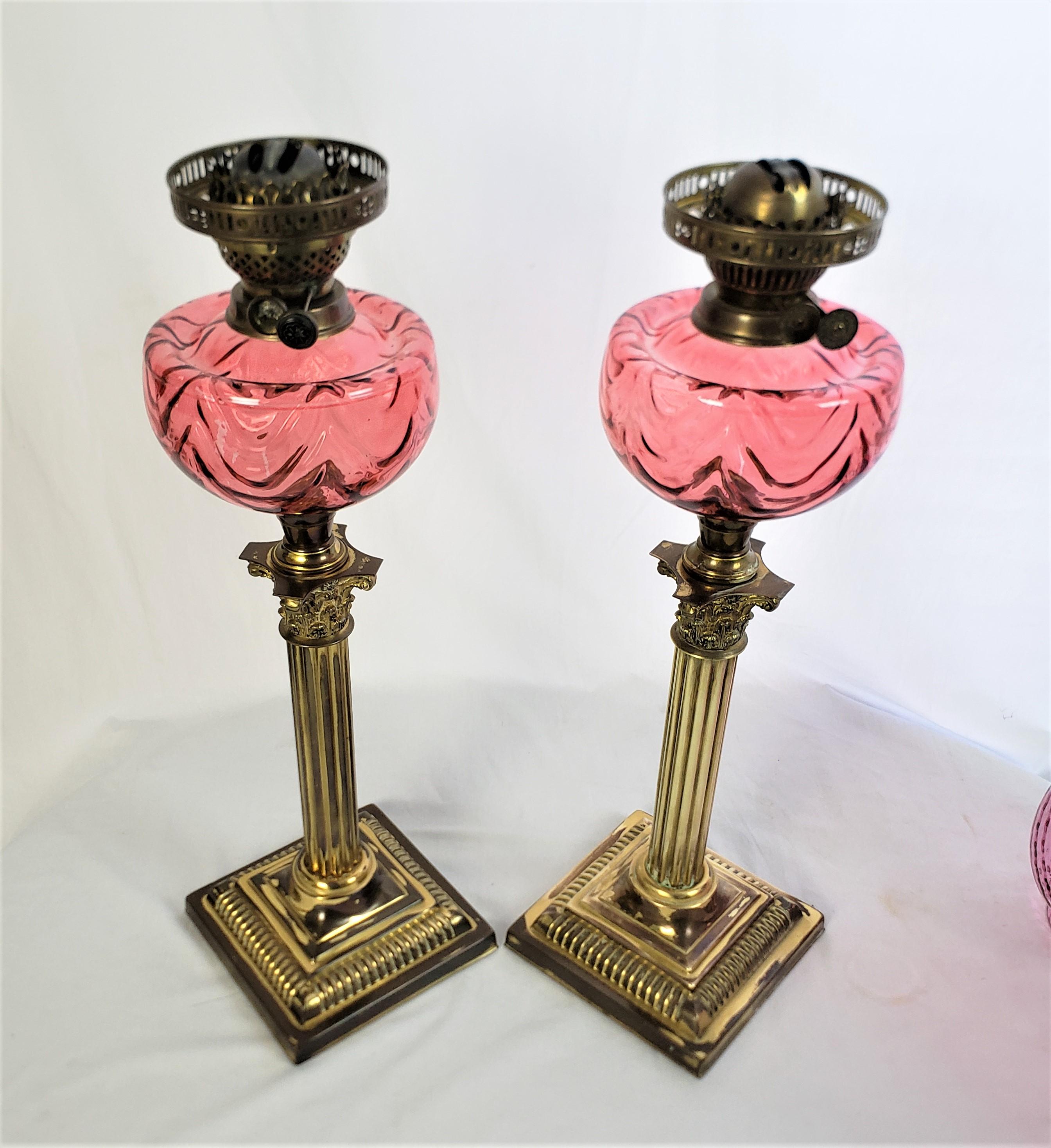 English Pair of Antique Cranberry & Brass Corinthian Column Banquet or Parlor Oil Lamps For Sale
