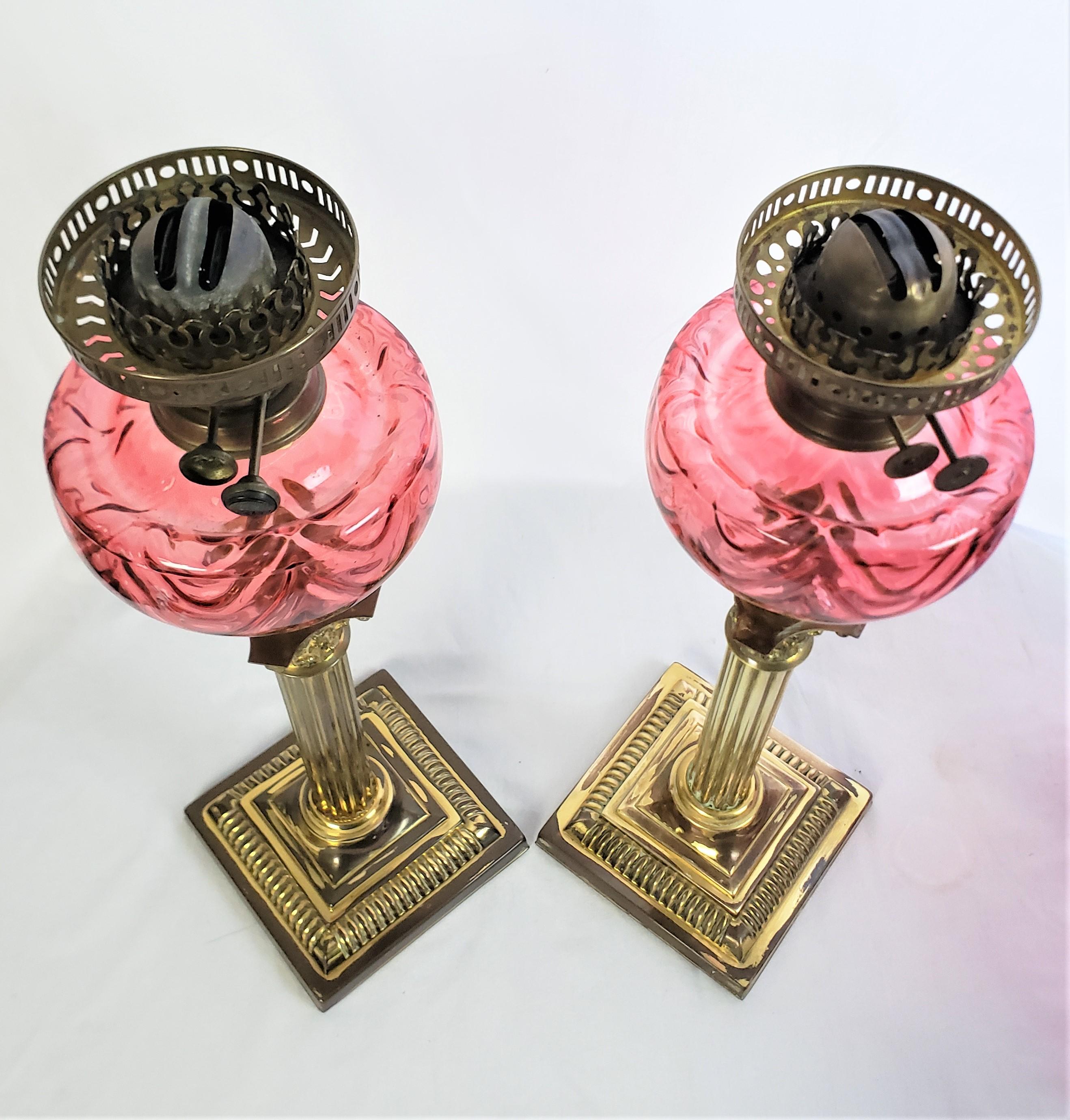 Hand-Carved Pair of Antique Cranberry & Brass Corinthian Column Banquet or Parlor Oil Lamps For Sale