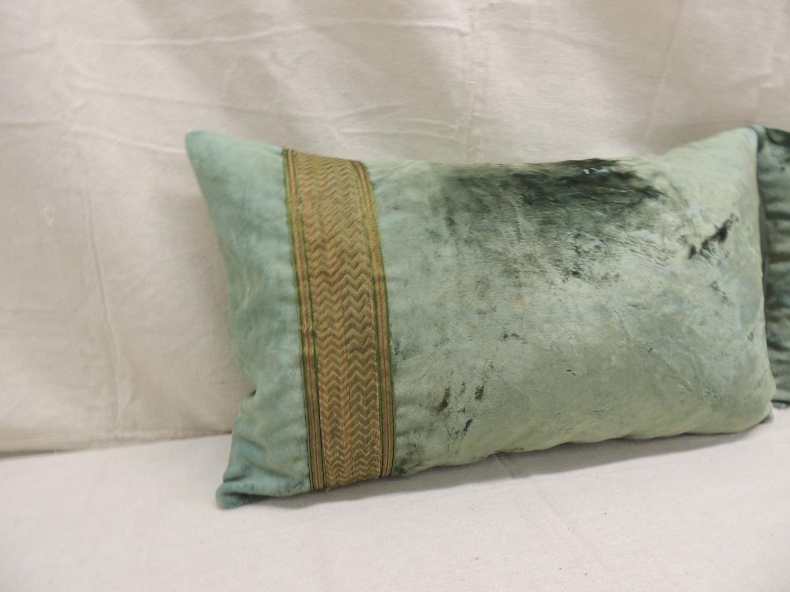 Pair of antique crushed velvet green and gold lumbar decorative pillows
with 19th century gold woven metallic trims, gold and green embellished flat trims and seafoam color silk backings.
Decorative pillow handcrafted and designed in the