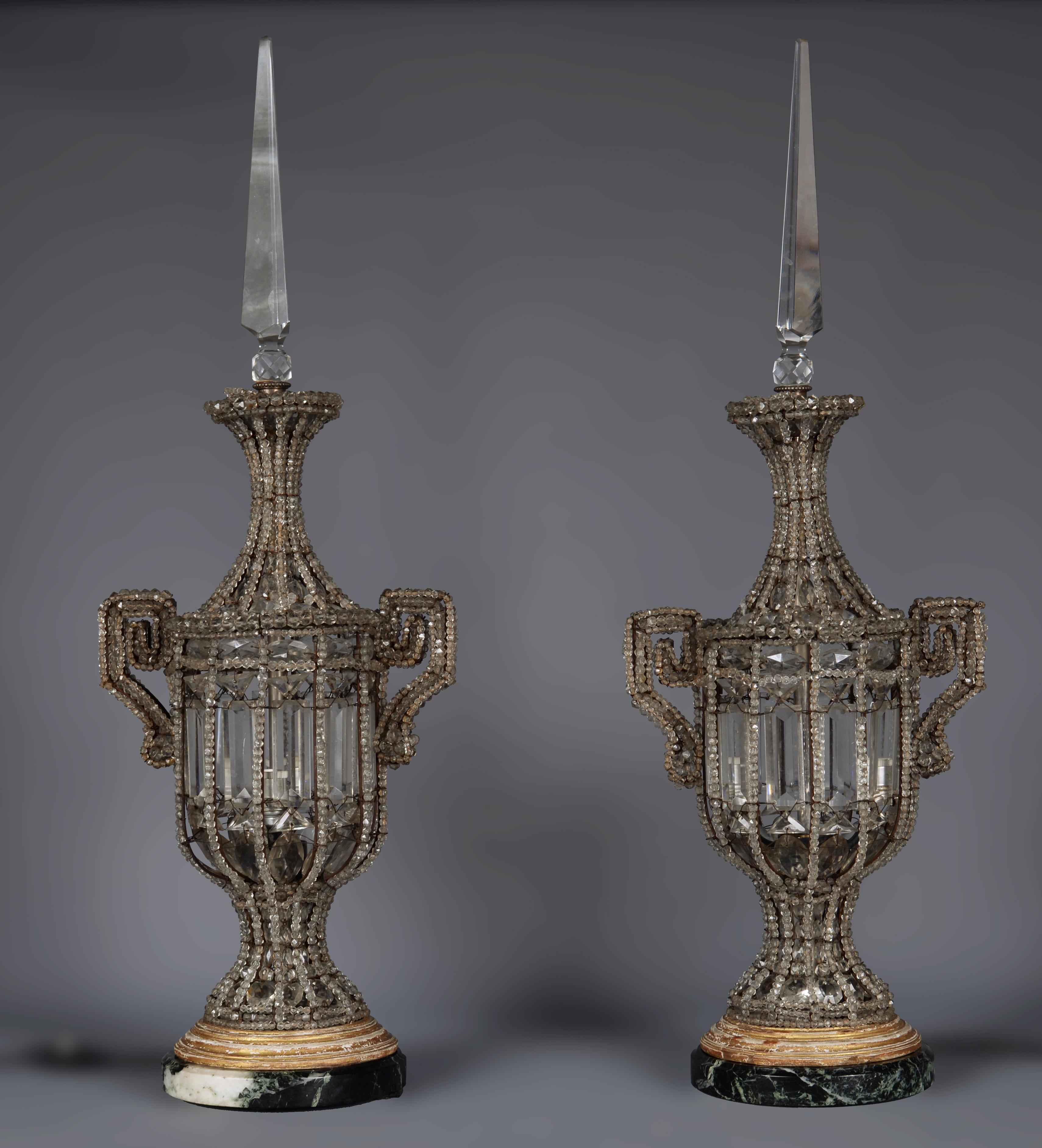 This beautiful pair of lamps was made of crystal in the late 19th century, early 20th
The lamps are composed of crystal pendants of different shapes and sizes attached together by iron strings, thus taking the shape of splendid vases flanked with