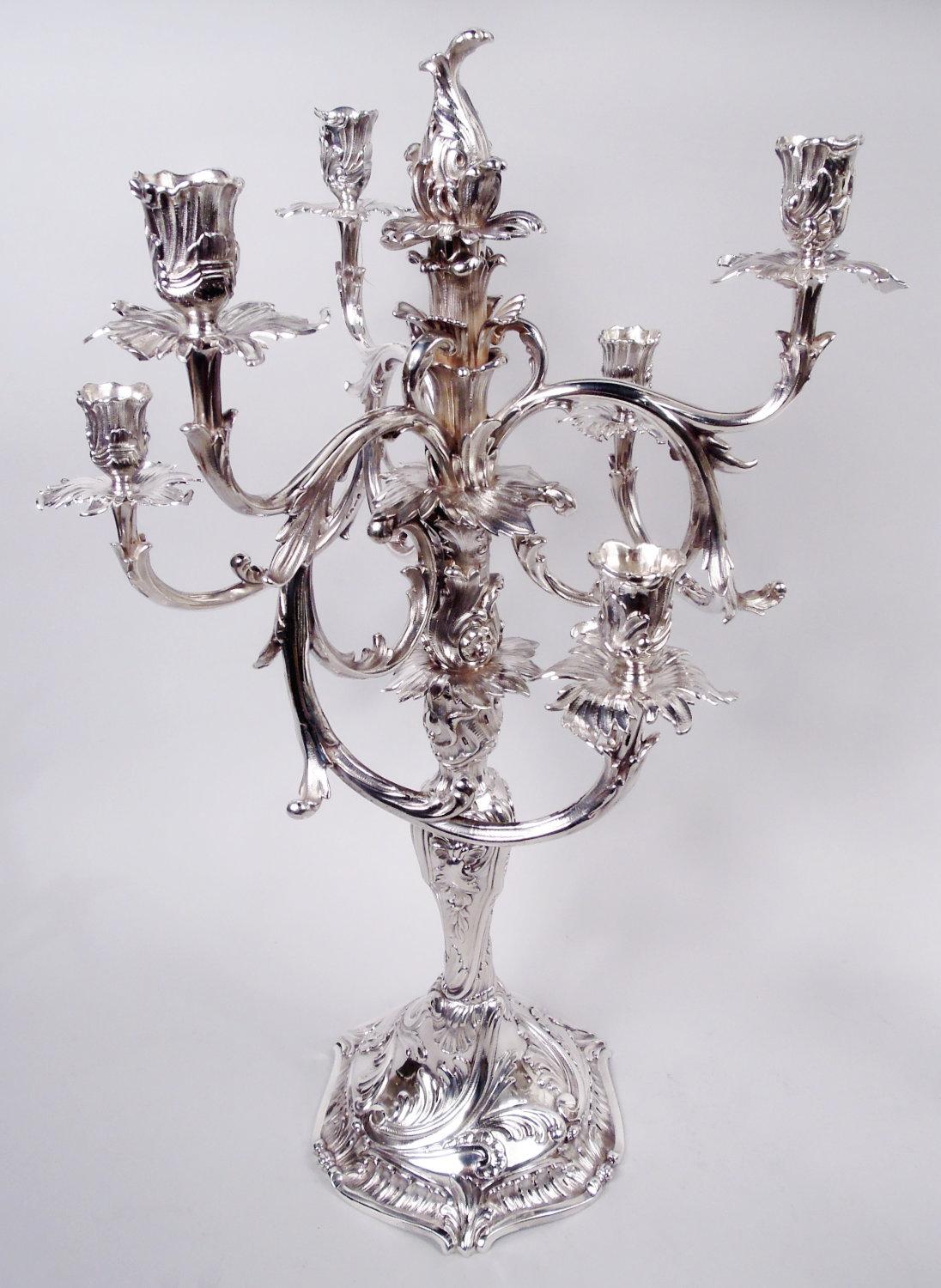 Pair of Danish Rococo sterling silver 7-light candelabra, 1914. Each: Central socket with detachable finial mounted with six scrolled arms, each terminating in single socket; twisted baluster shaft on domed foot with scrolled and bead-and-reel rim.