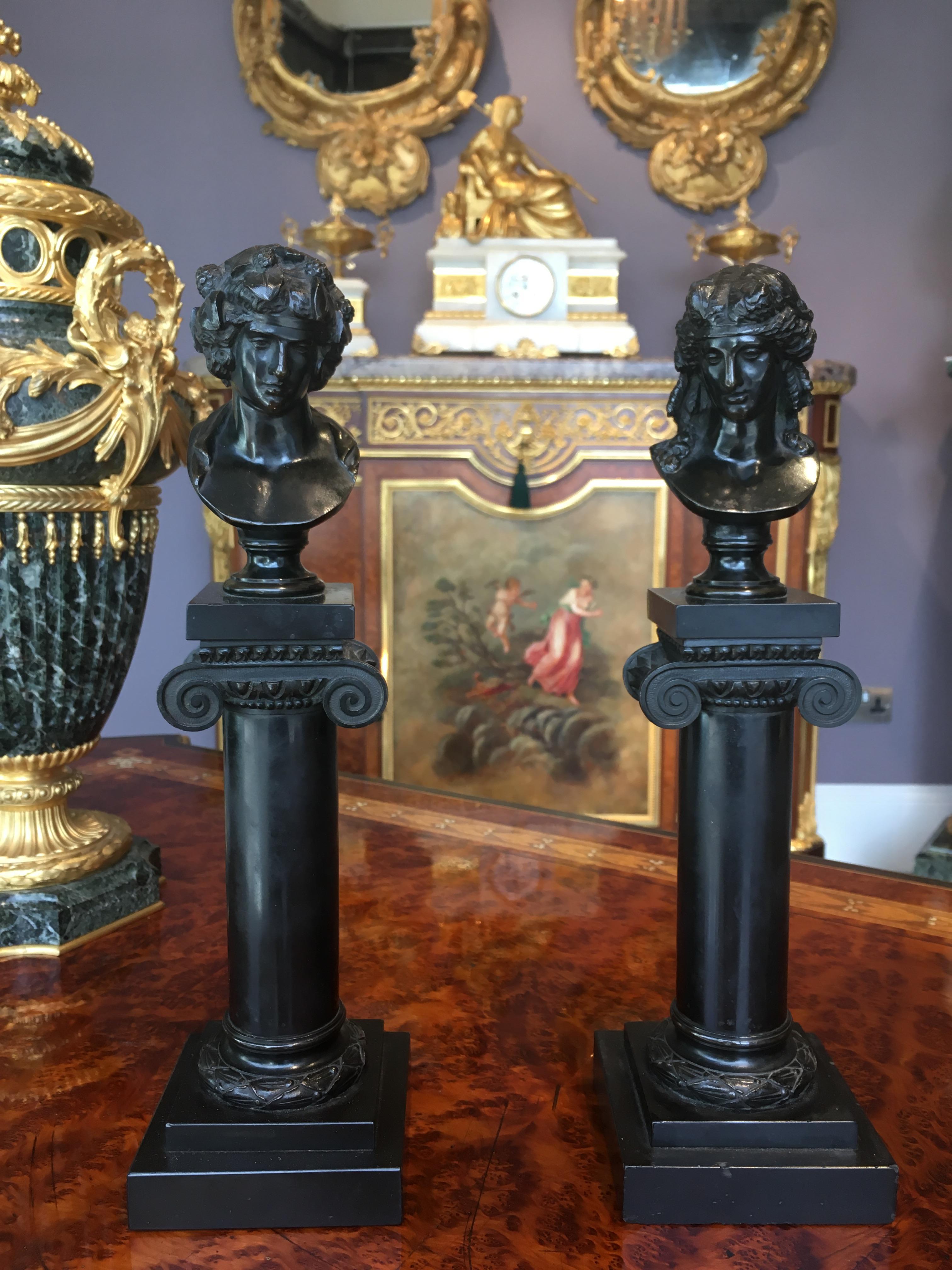 A Pair of Miniature Bronzes of Roman Busts
On Marmore Nero Columns
In the Manner of Georges Servant

After the original models exhibited at the Paris exposition universelle of 1867, the two patinated bronze busts representing the Roman god Bacchus