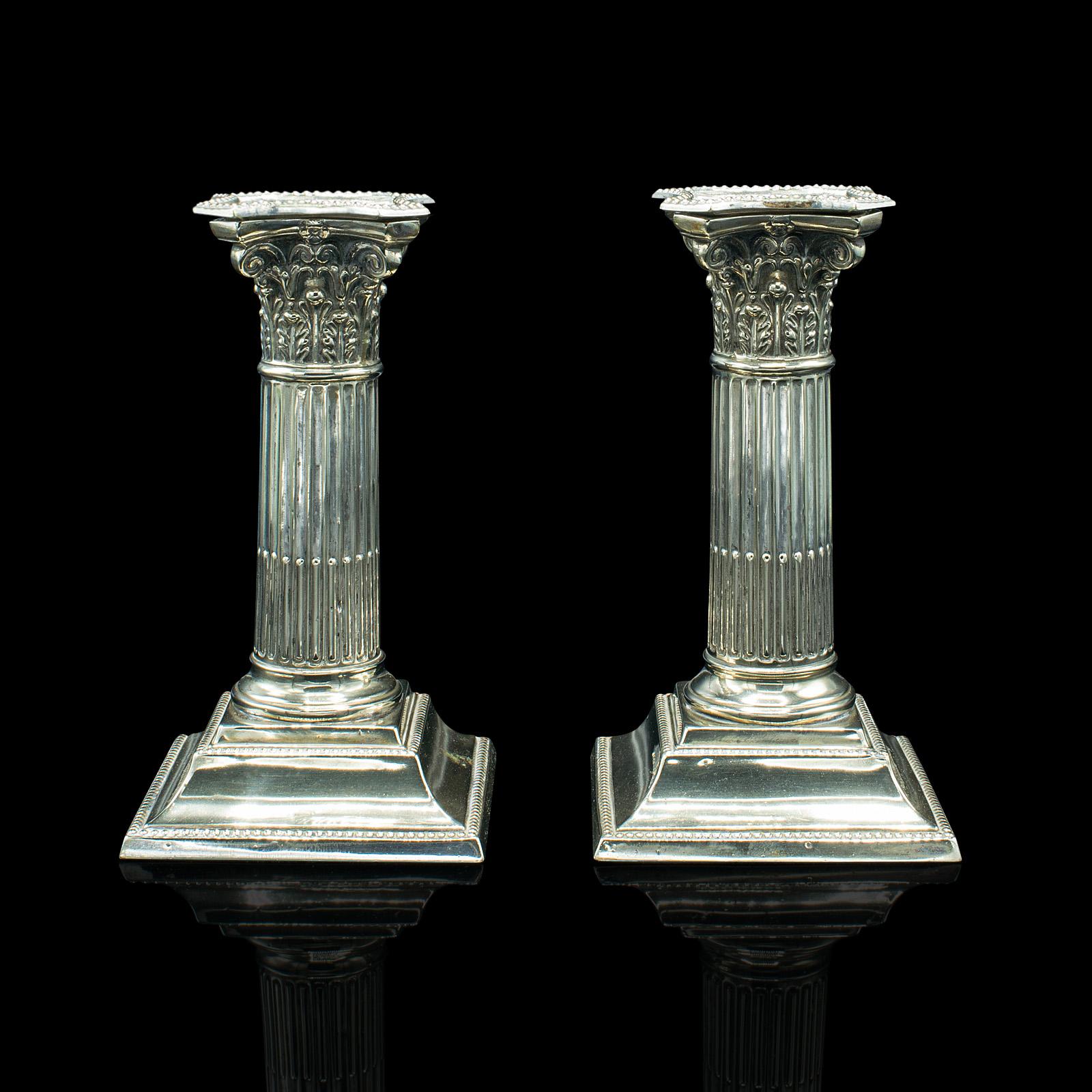 This is a pair of antique decorative candlesticks. An Italian, silver plate Grand Tour candle holder, dating to the mid Victorian period, circa 1860.

Delightfully classical taste in the form of Corinthian columns
Displaying a desirable aged