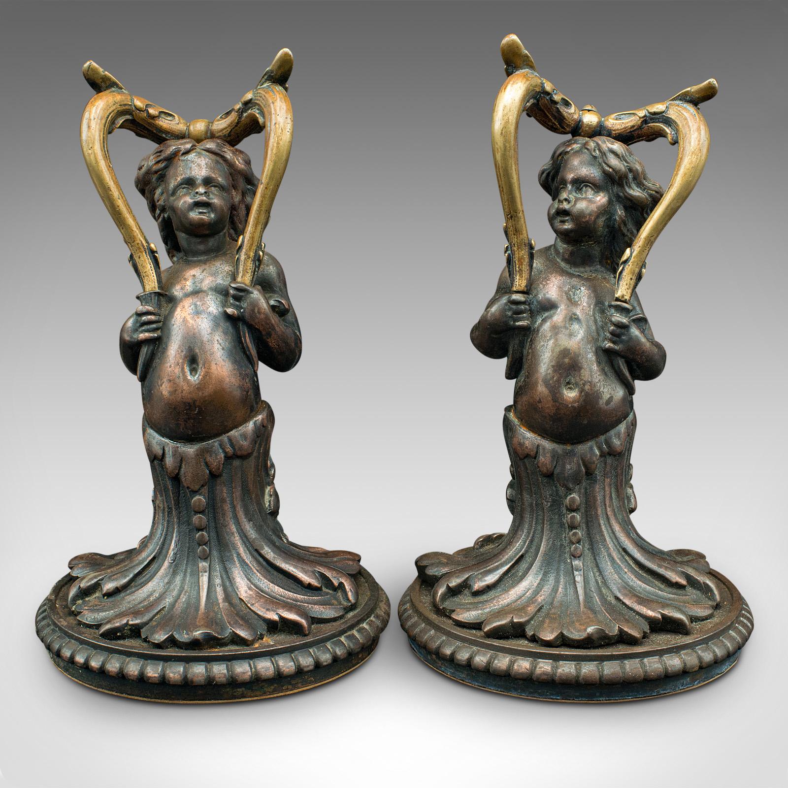 This is a pair of antique decorative cherubs. An English, bronze doorstop or fireside figure, dating to the late Victorian period, circa 1900.

Highly distinctive decorative cherub figures
Displaying a desirable aged patina and in good order
Quality