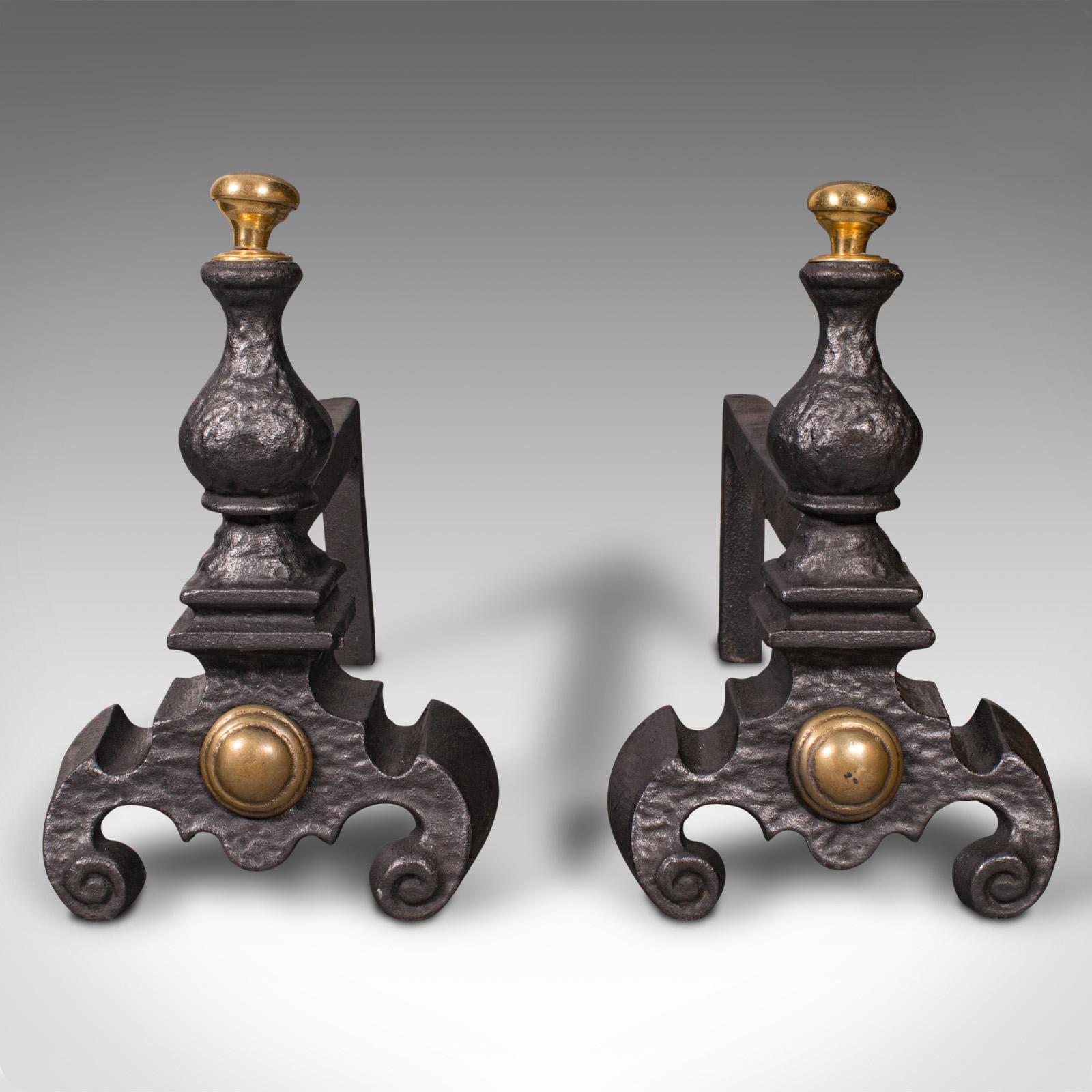 This is a pair of antique decorative fire rests. An English, cast iron fireside andiron, dating to the mid Victorian period, circa 1850.

Eye-catching fireside tool rests with polished mounts
Displaying a desirable aged patina and in good