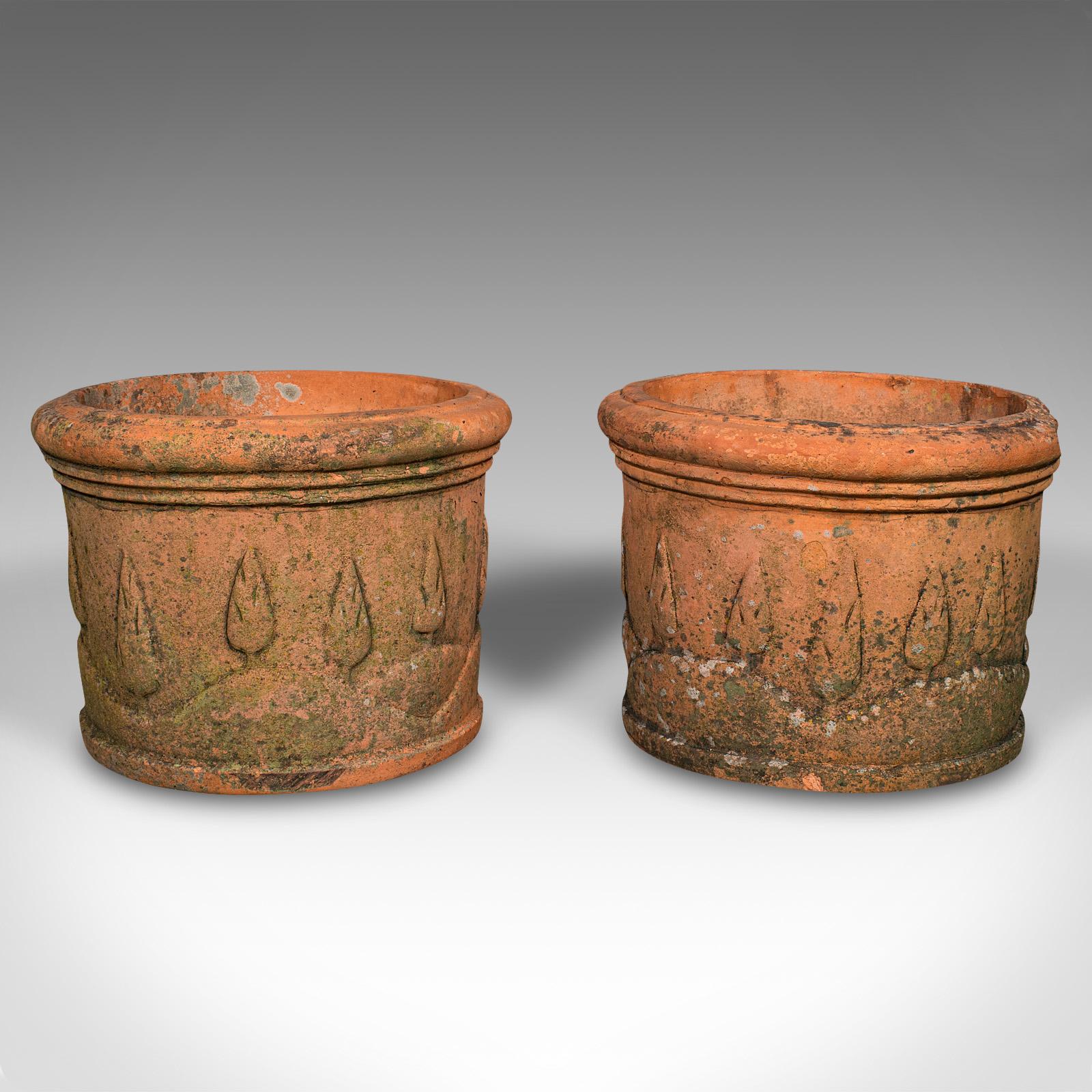 This is a pair of antique decorative planters. An Italian, terracotta outdoor jardiniere with Tuscan decor, dating to the late Victorian period, circa 1900.

Appealingly weathered with a charming decorative relief pattern
Displays a desirable aged