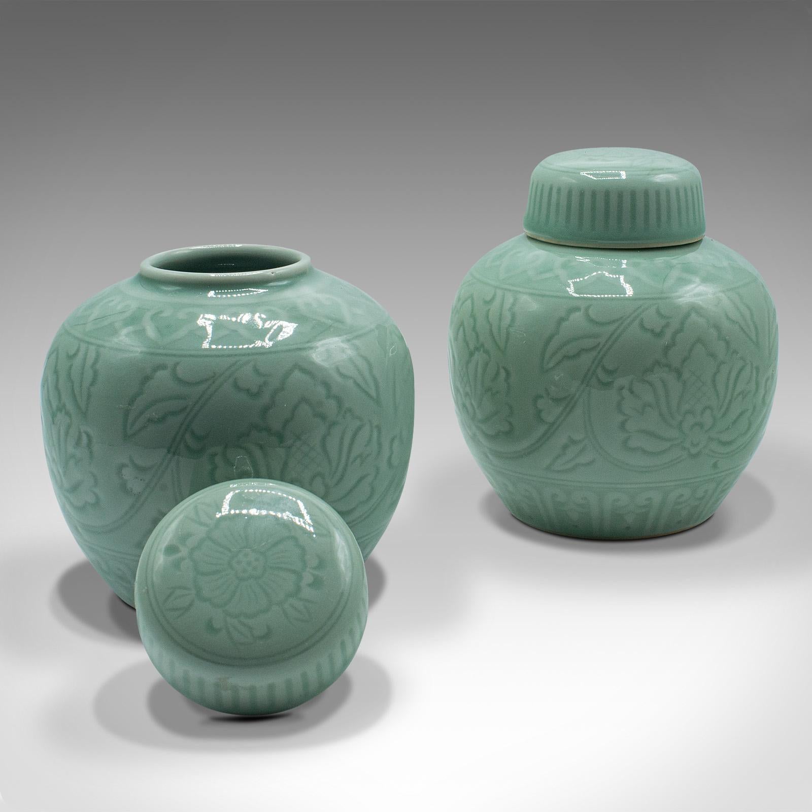 This is a pair of antique decorative spice jars. A Chinese, celadon ceramic pot, dating to the late Victorian period circa 1900.

Delightful form with wonderful celadon green hues
Displays a desirable aged patina and in very good order
Glazed
