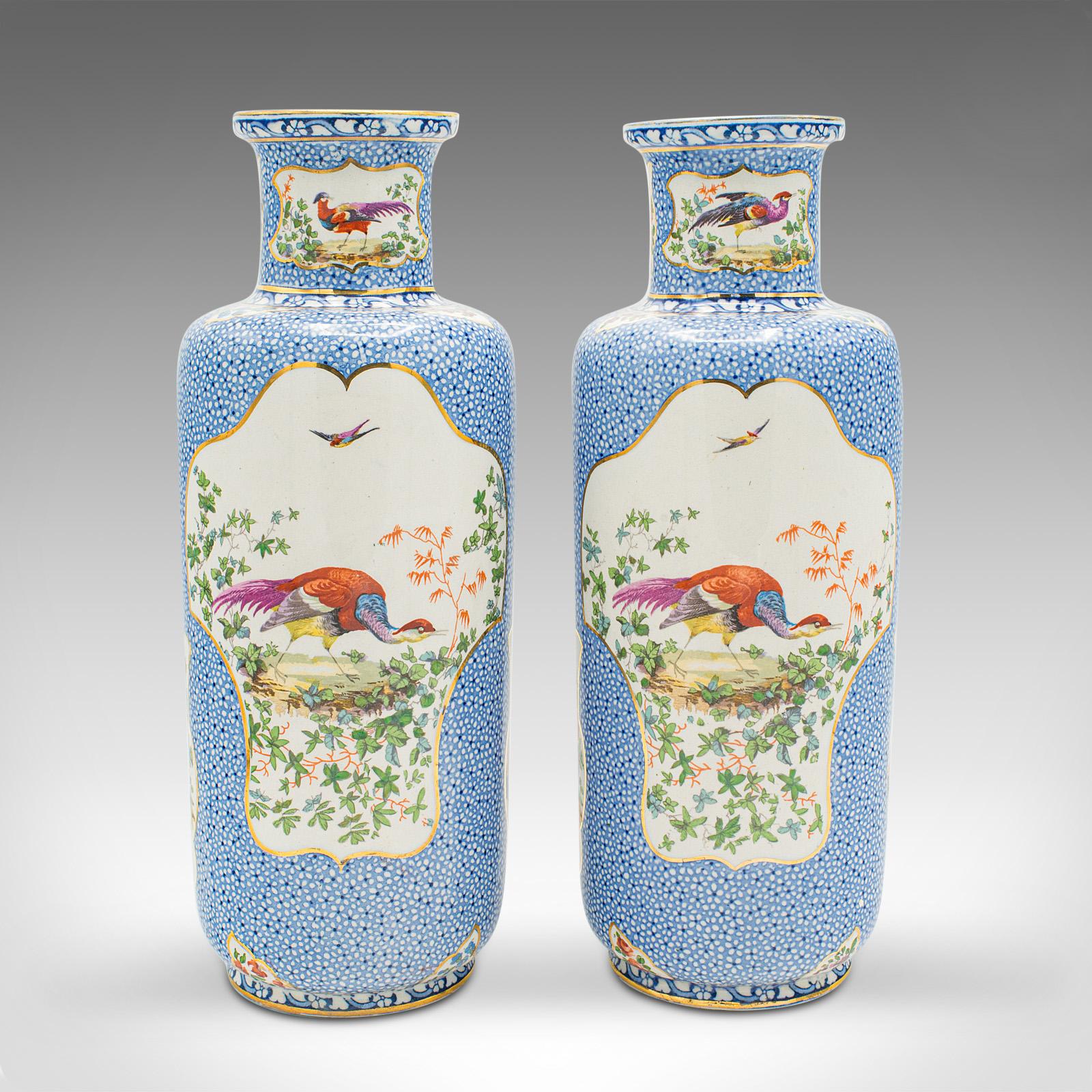 This is a pair of antique decorative stem vases. An English ceramic flower sleeve, dating to the Edwardian period, circa 1910.

Profusely decorated vases boasting fine colour and animal interest
Displays a desirable aged patina and in good