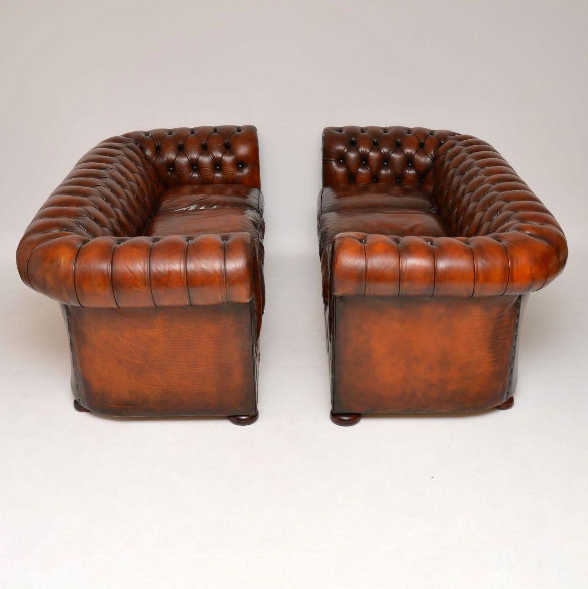 Fabulous pair of antique deep buttoned leather chesterfield three seater sofas in very good condition & dating to around the 1950s period. They are virtually identical & came out of the same residence, so they must have been bought together