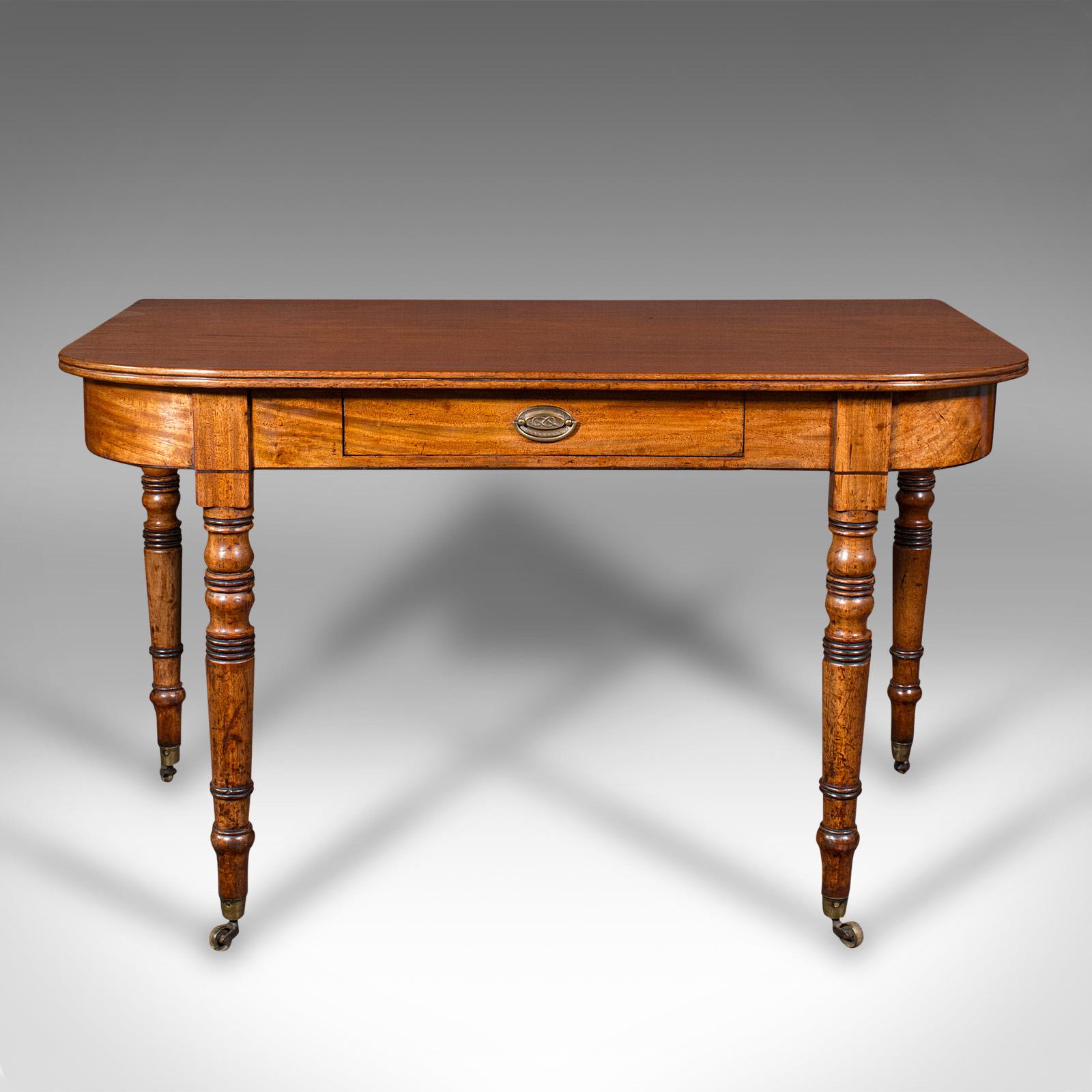 This is a pair of antique demi-lune end tables. An English, mahogany side table, dating to the Regency period, circa 1820.

Superior quality tables, with delightful Regency craftsmanship
Displaying a desirable aged patina and in good order
Select