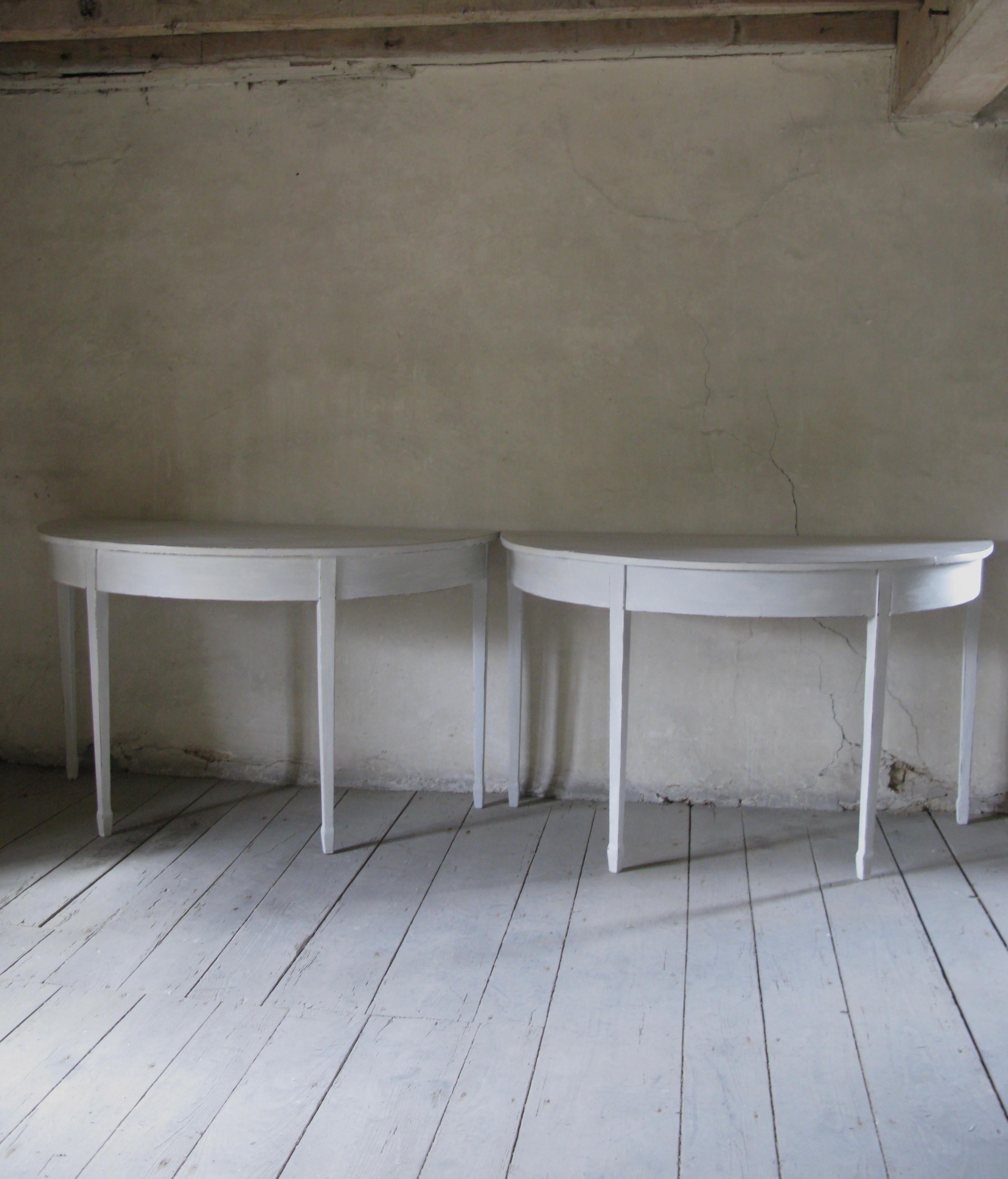 A lovely pair of decorative 19th century painted demi-lune tables
painted in Gustavian style

Thes english tables from circa 1880s features a wide semi-circular top

This table is raised upon gently tapered legs. 

Soft lovely patine with clear