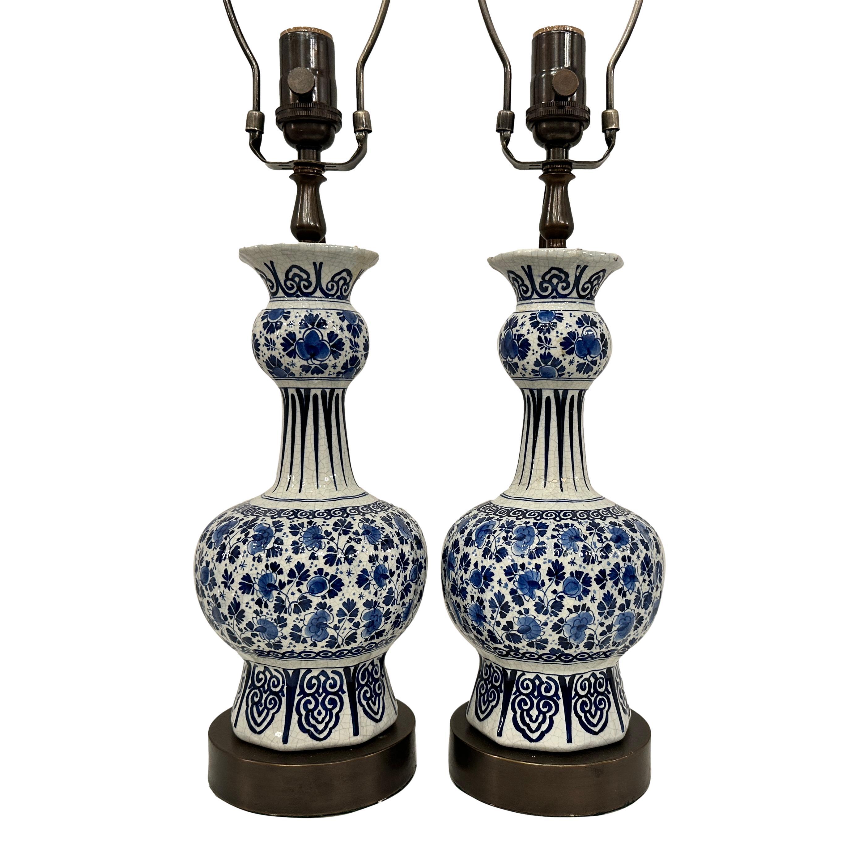 Pair of circa 1920's hand-painted Dutch porcelain table lamps.

Measurements:
Height of body: 14