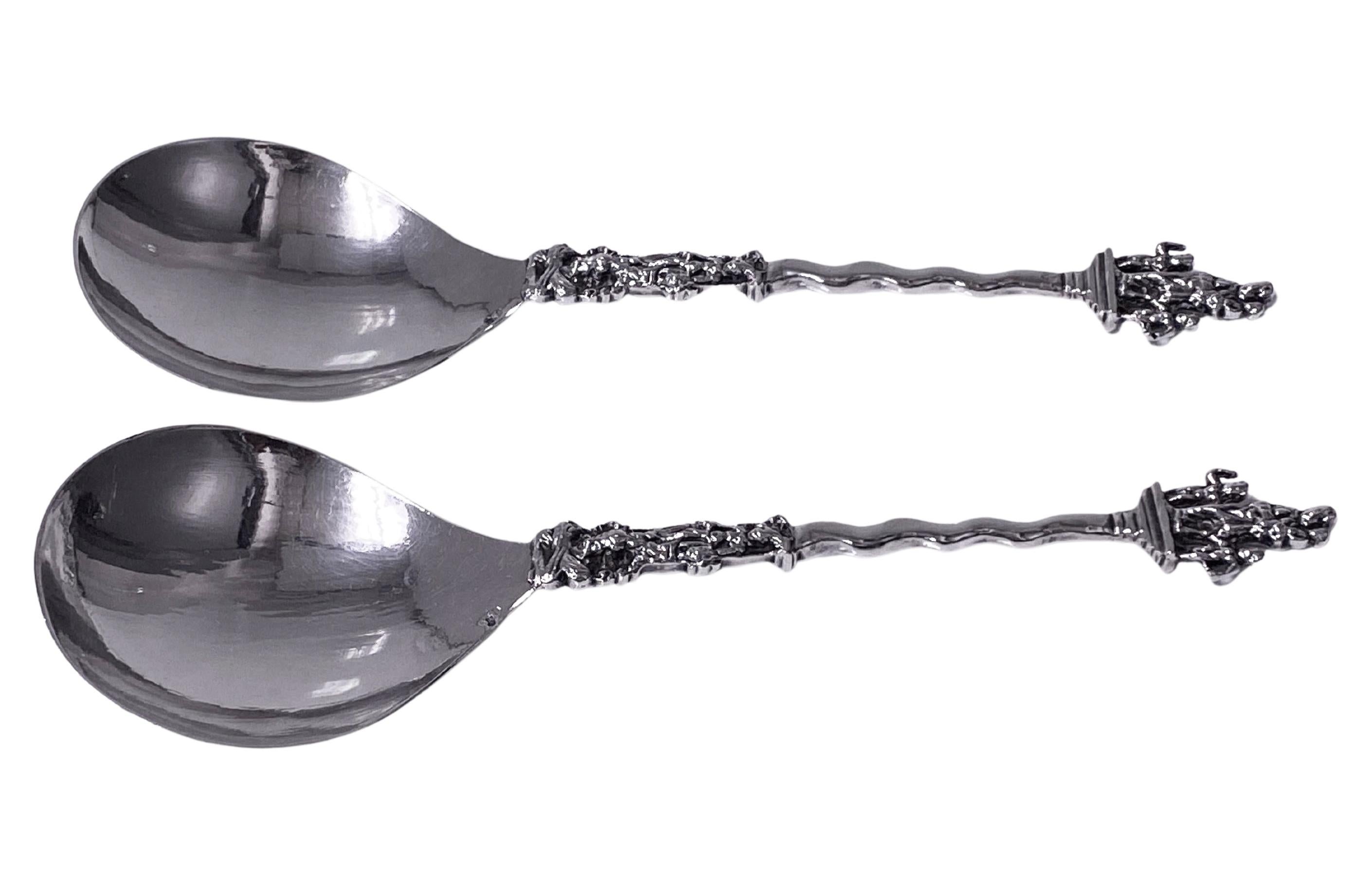 Pair of Antique Dutch Silver figural Spoons, C.1890. Each depicting at the top a figural scene of woman holding a baby with a standing child on either side, twist stems and further figural scenes to lower part of stem. The reverse bowls of each