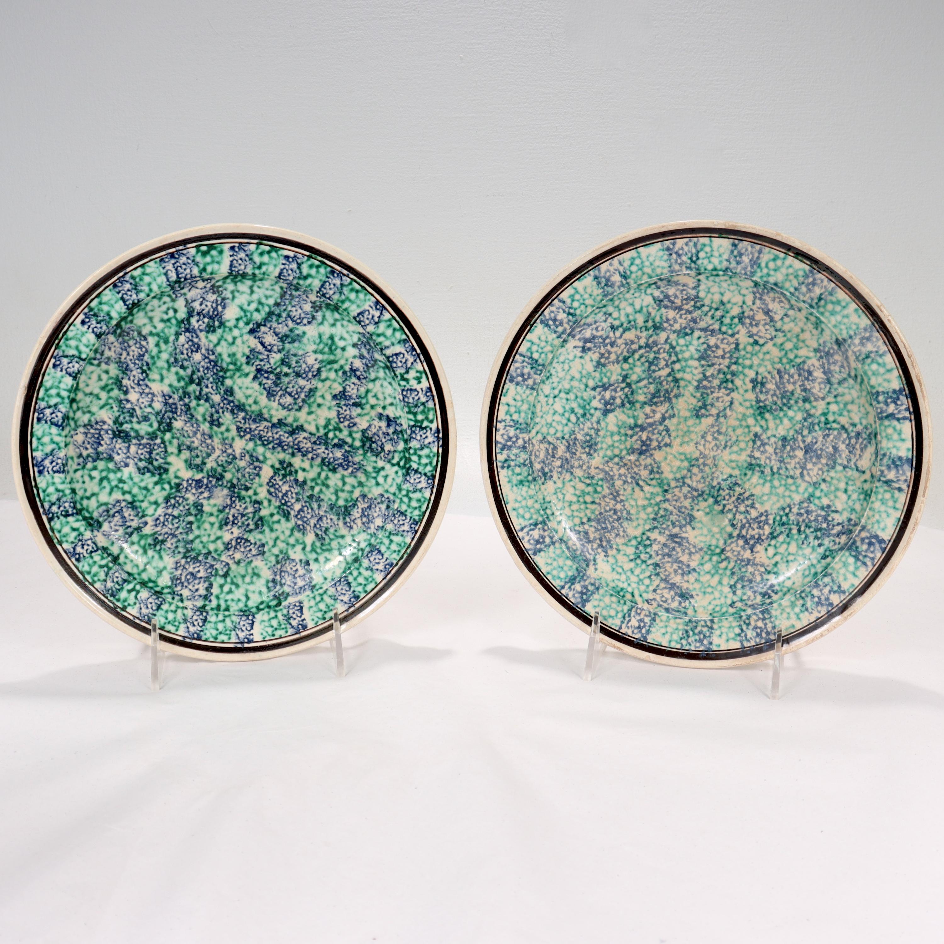 A fine pair of 19th century English Spongeware pottery plates.

Both plates with green & blue painted decoration that appears to have been dabbed or spread with a sponge, hence the name spongeware. 

One of the plates has some overpaint and is