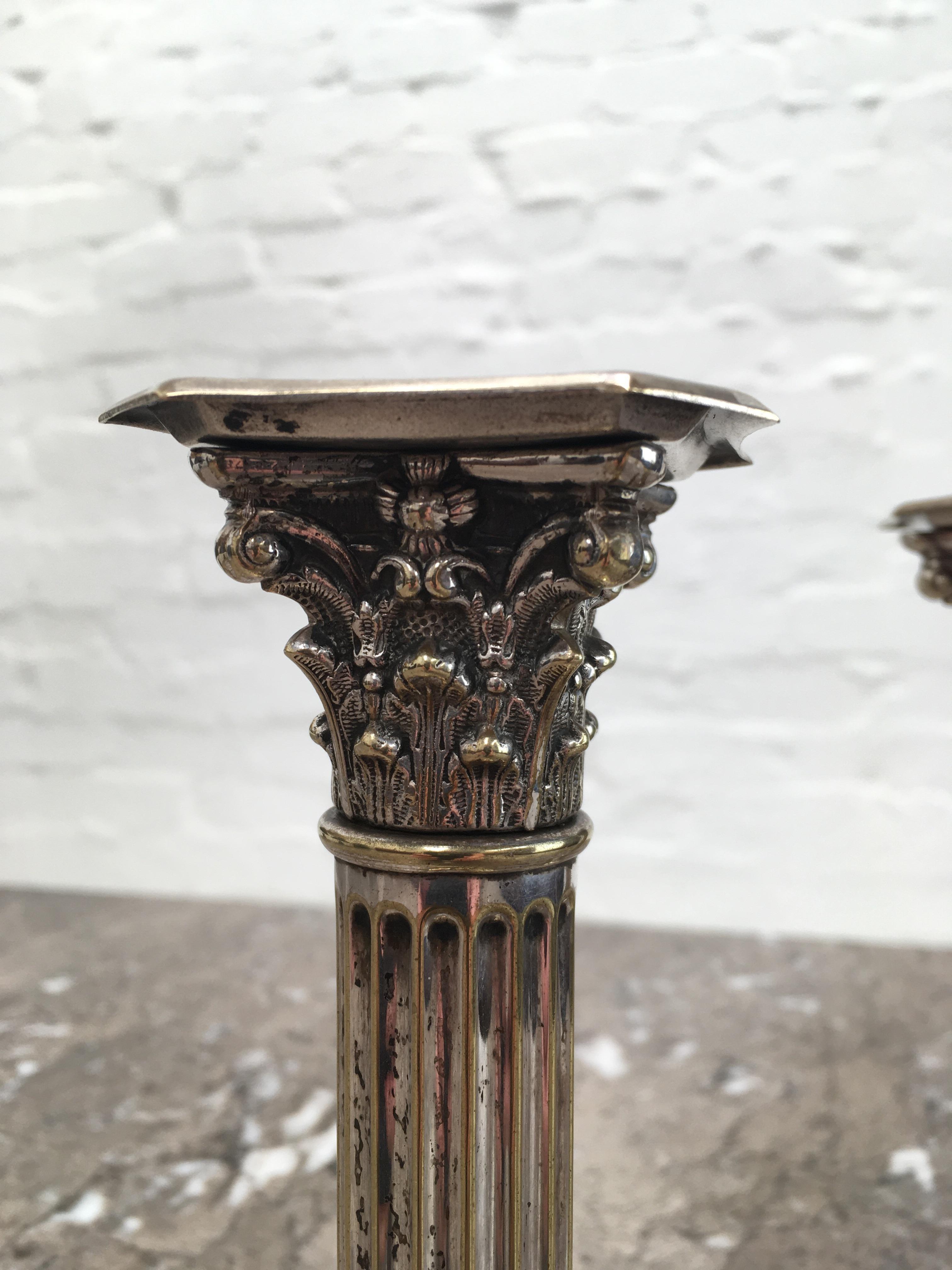 We present this pair of Edwardian candlesticks in aged, distressed condition. Perfect for a tableau of time-worn pieces or to enhance an historical interior or table setting. We particularly adore the Corinthian capitals, done in wonderful detail.