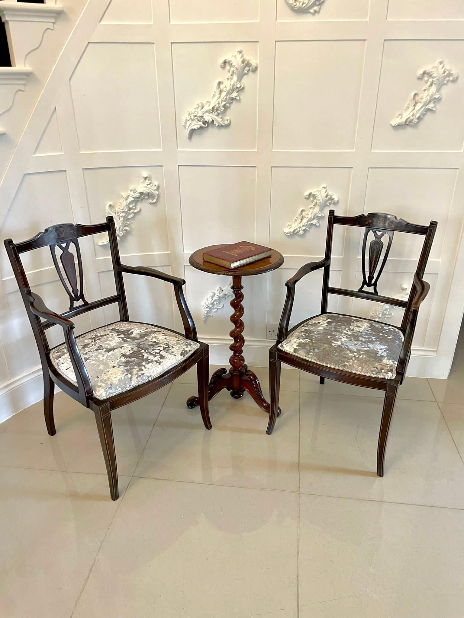 Pair of antique Edwardian mahogany inlaid armchairs with an elegant inlaid shaped top rail and centre splat. Newly recovered seats in a quality stylish fabric. They are supported by attractive shaped inlaid front legs and out swept back legs

An