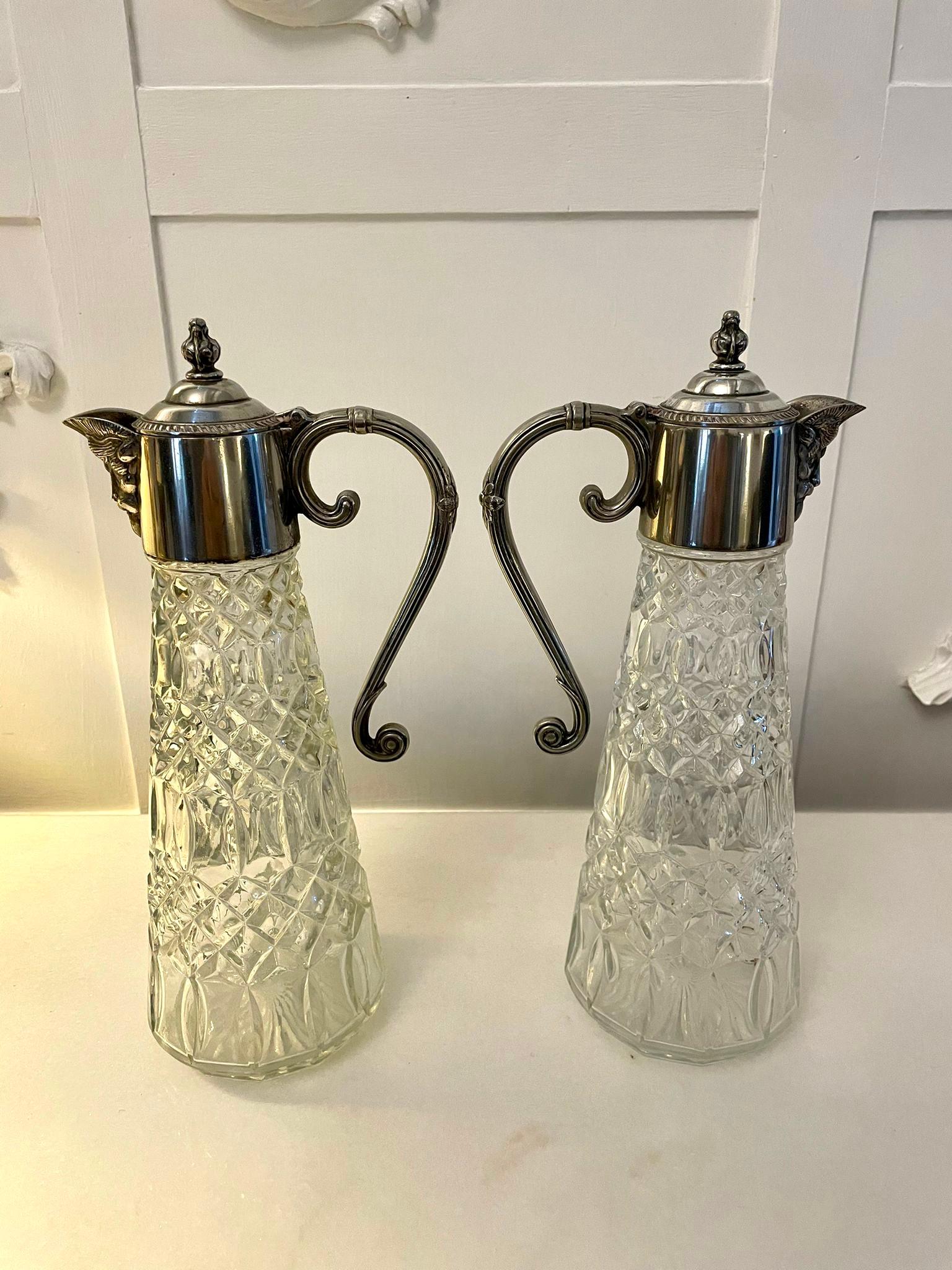 Pair of antique Edwardian quality silver plated and cut glass claret jugs having silver plated shaped lift up lids with elegant handles and attractive cut glass claret jugs.

A very desirable pair in wonderful original condition.

Measures: H