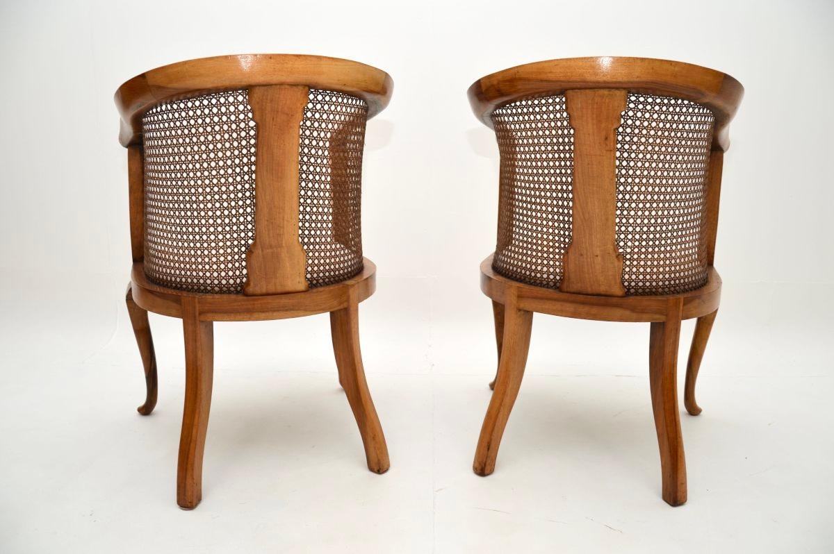 Early 20th Century Pair of Antique Edwardian Walnut Cane Back Armchairs For Sale