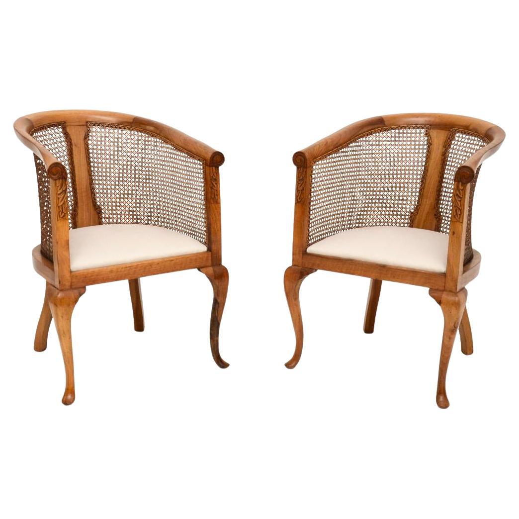 Pair of Antique Edwardian Walnut Cane Back Armchairs For Sale