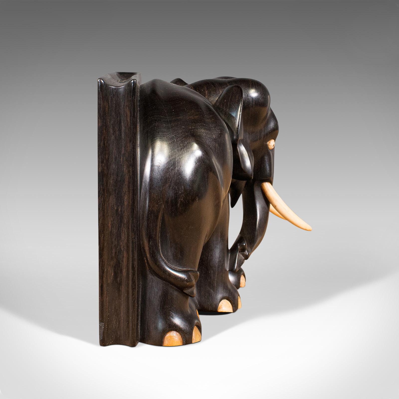 antique wooden elephants with ivory tusks