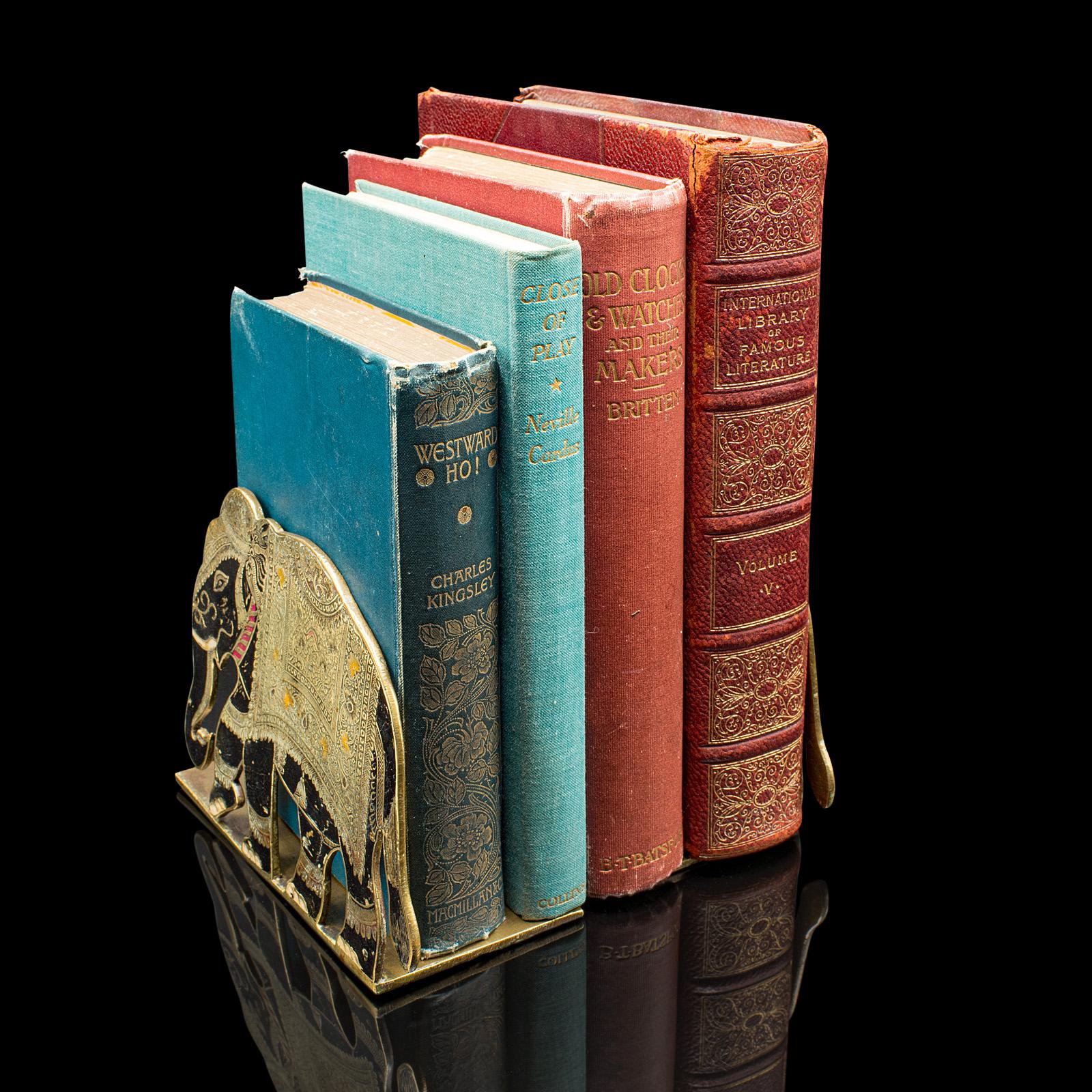 This is a fine pair of antique elephant bookends. An Indian, etched brass decorative book rest, dating to the late Victorian period, circa 1880. Bursting with charm and rich detail, these bookends offer a distinctive addition to your library or
