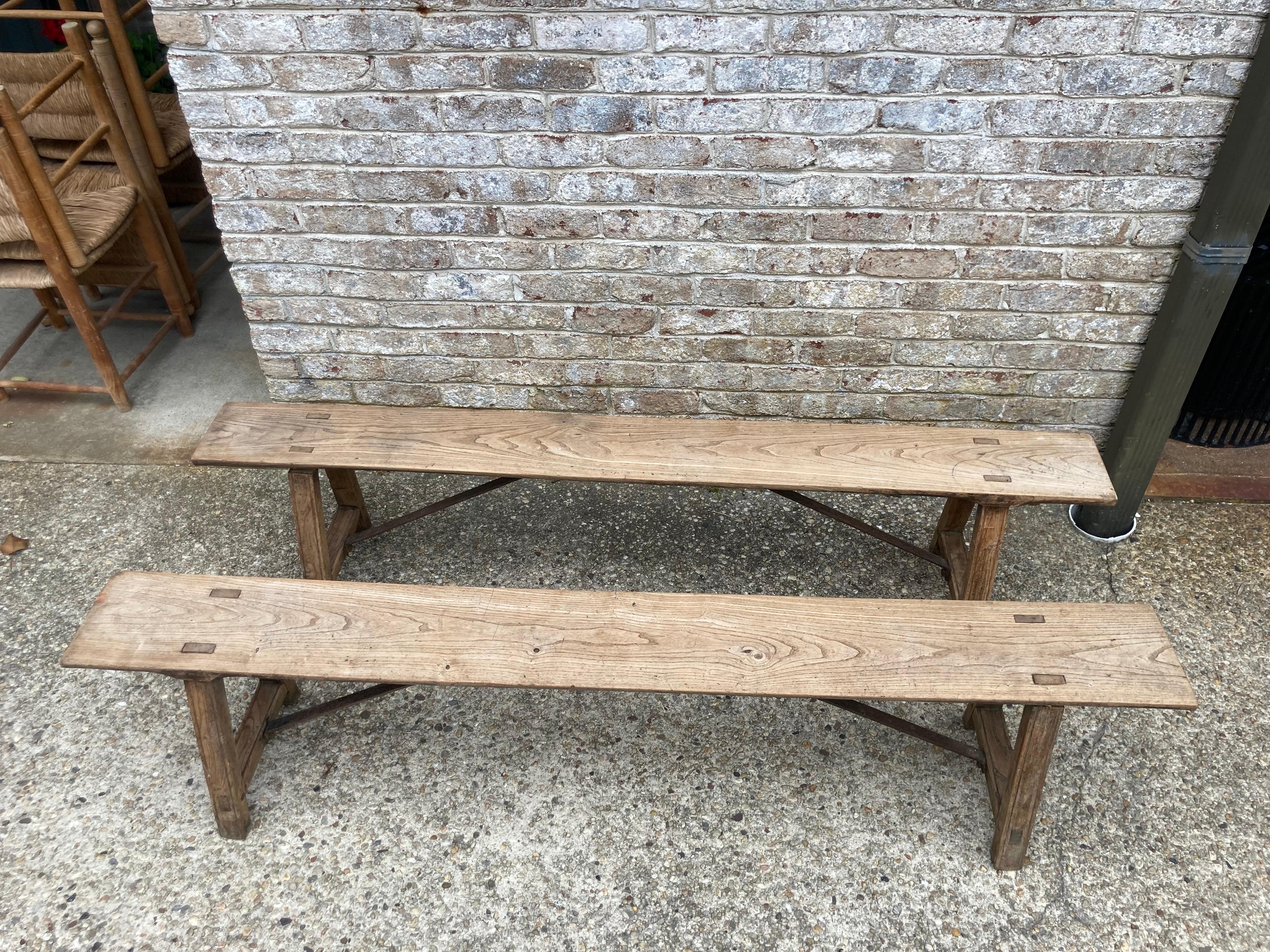 Pair of antique elm wood benches with iron stretchers.... the seat depth is 8.25