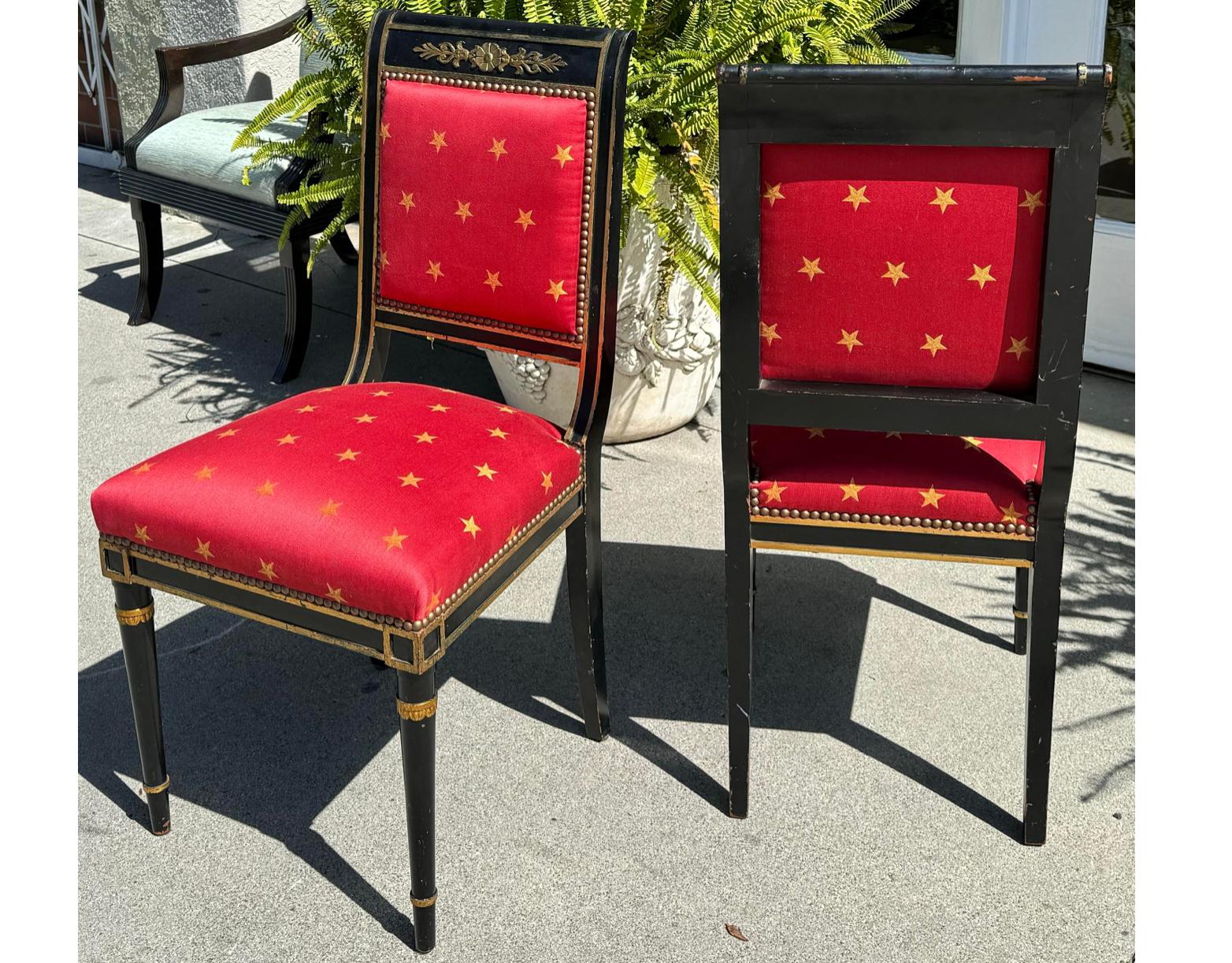 Pair of Antique Empire Black & Gold Chairs W Red Clarence House Seats.  Each has been freshly upholstered in red Clarence House fabric with gold stars. This listing is from one pair of chairs but we actually have three pair available. 