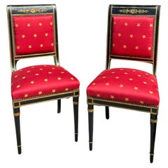 Paar antike Empire-Stühle in Schwarz und Gold mit roten Clarence House-Sitzen