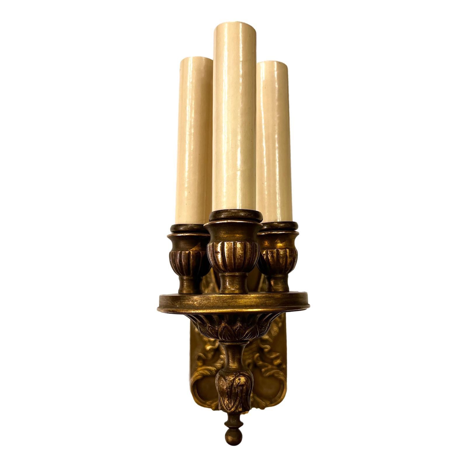A pair of circa 1920s French Empire style three-light sconces with original patina.

Measurements:
Height: 9