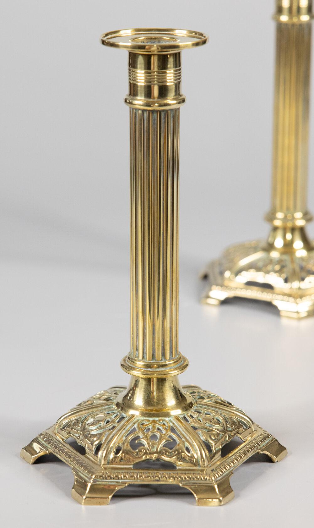 A fine pair of English Neoclassical style cast brass candlesticks, circa 1890. No maker's mark. These handsome candlesticks are well cast and heavy with stately reeded columns and ornate bases. They are a nice large size at 9