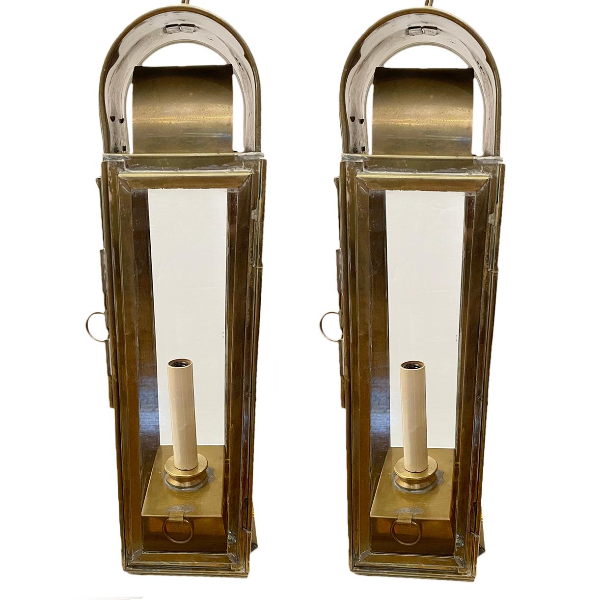 A pair of circa 1920's patinated brass lantern sconces with one interior light.

Measurements:
Height: 18.5